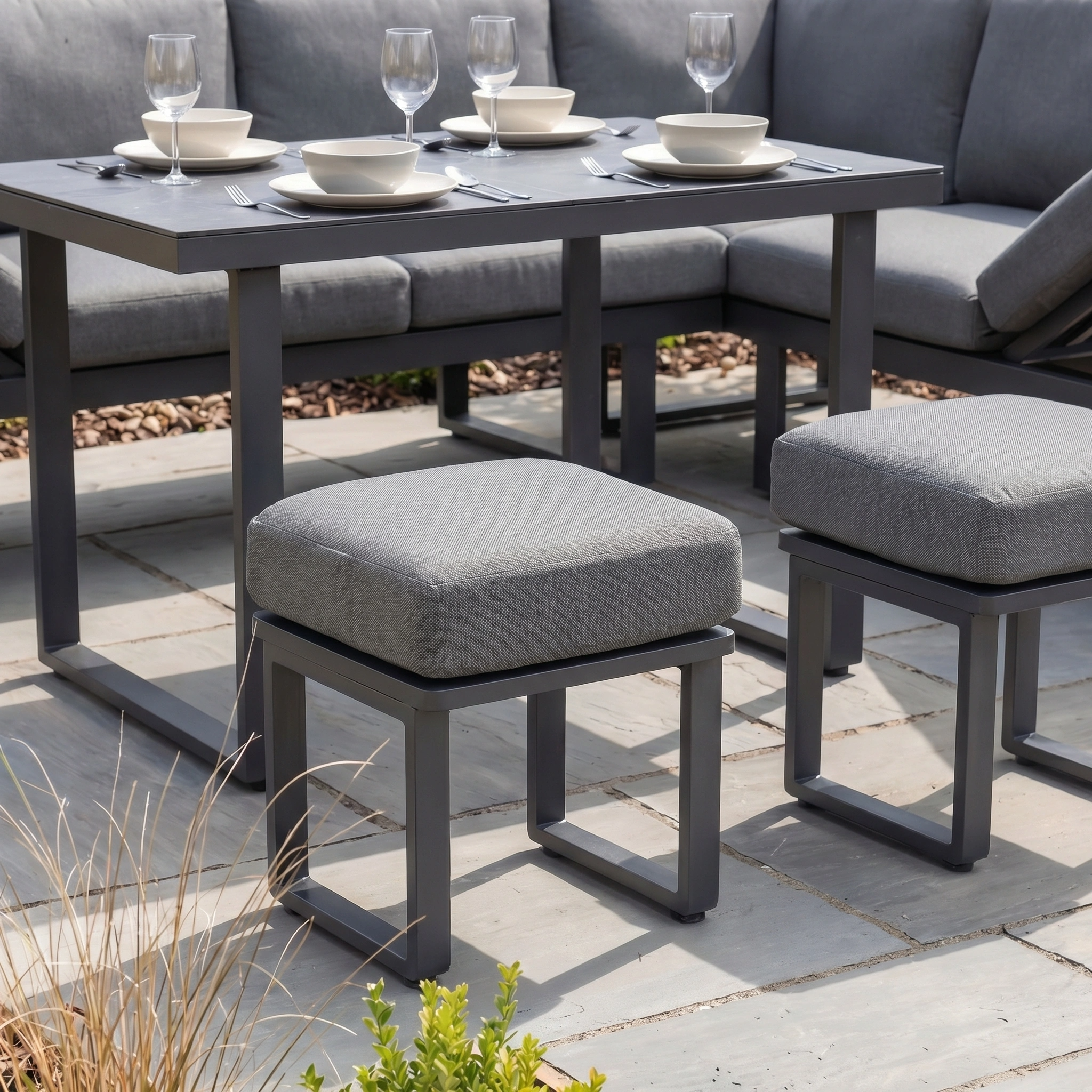 Lyra Corner Dining Set in Charcoal with gray cushions and aluminium frame—stylish garden furniture ideal for your stone patio.