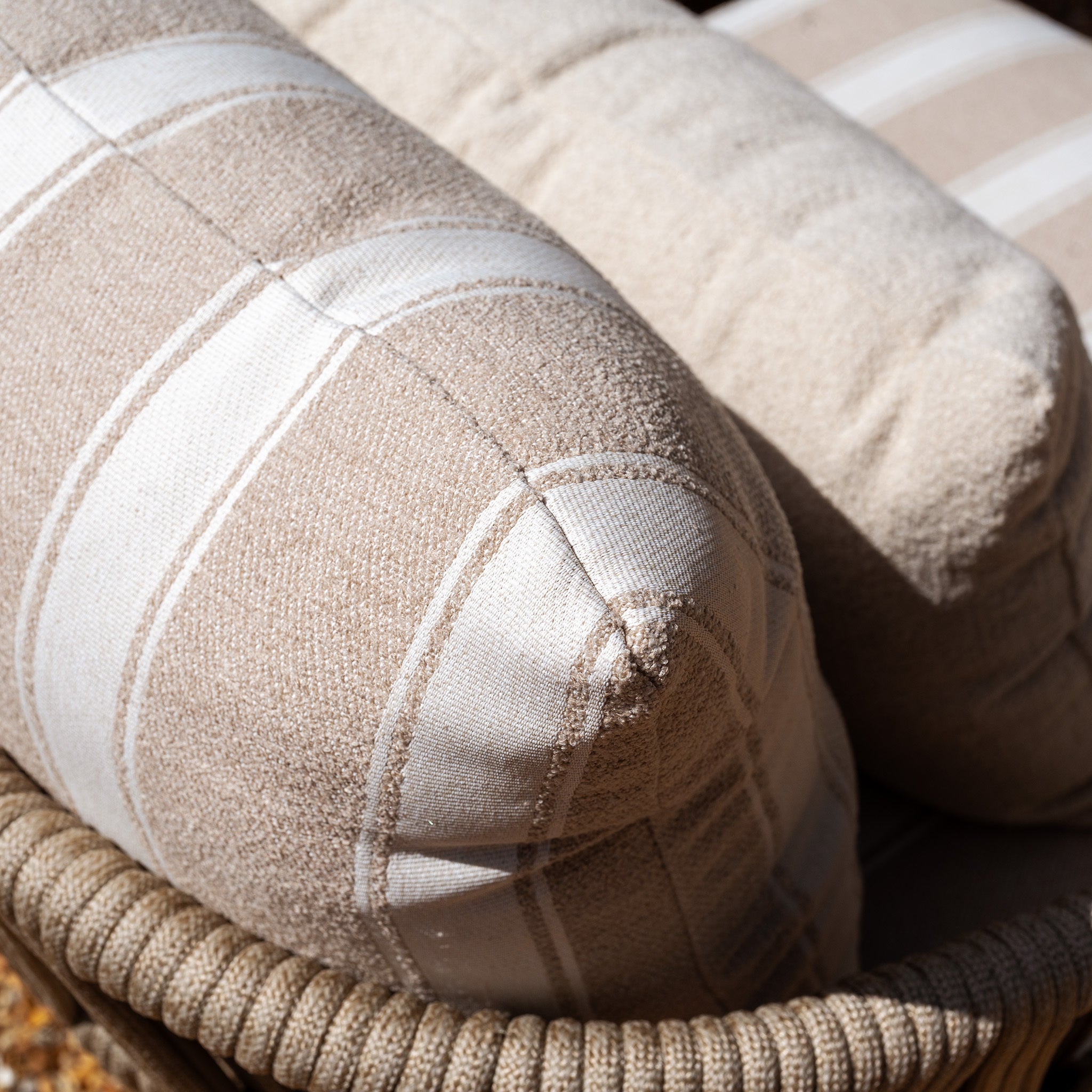 Close-up of the Madeira 3 Seat Sofa in Striped Latte (Ex Display) basking in sunlight, its beige and white striped design adding a stylish accent to your garden furniture or outdoor sofa set.