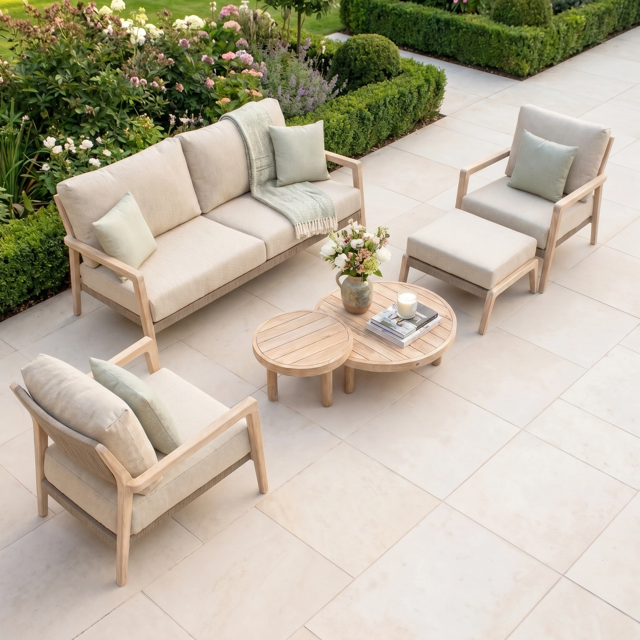 The Noah 3 Seat Sofa Set in Volga Grey features durable outdoor furniture with beige cushions and a wooden coffee table, perfect for relaxing in your lush garden.