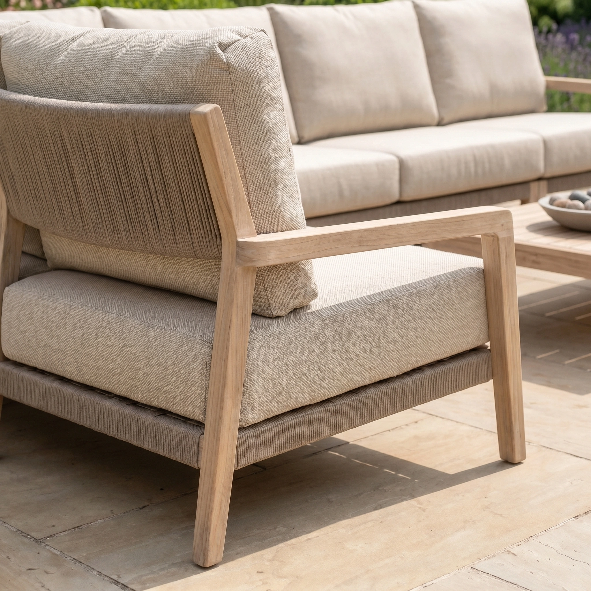 Close-up of the Noah Corner Sofa Set in Volga Grey with wooden frames on a tiled patio, showcasing elegant teak outdoor furniture.