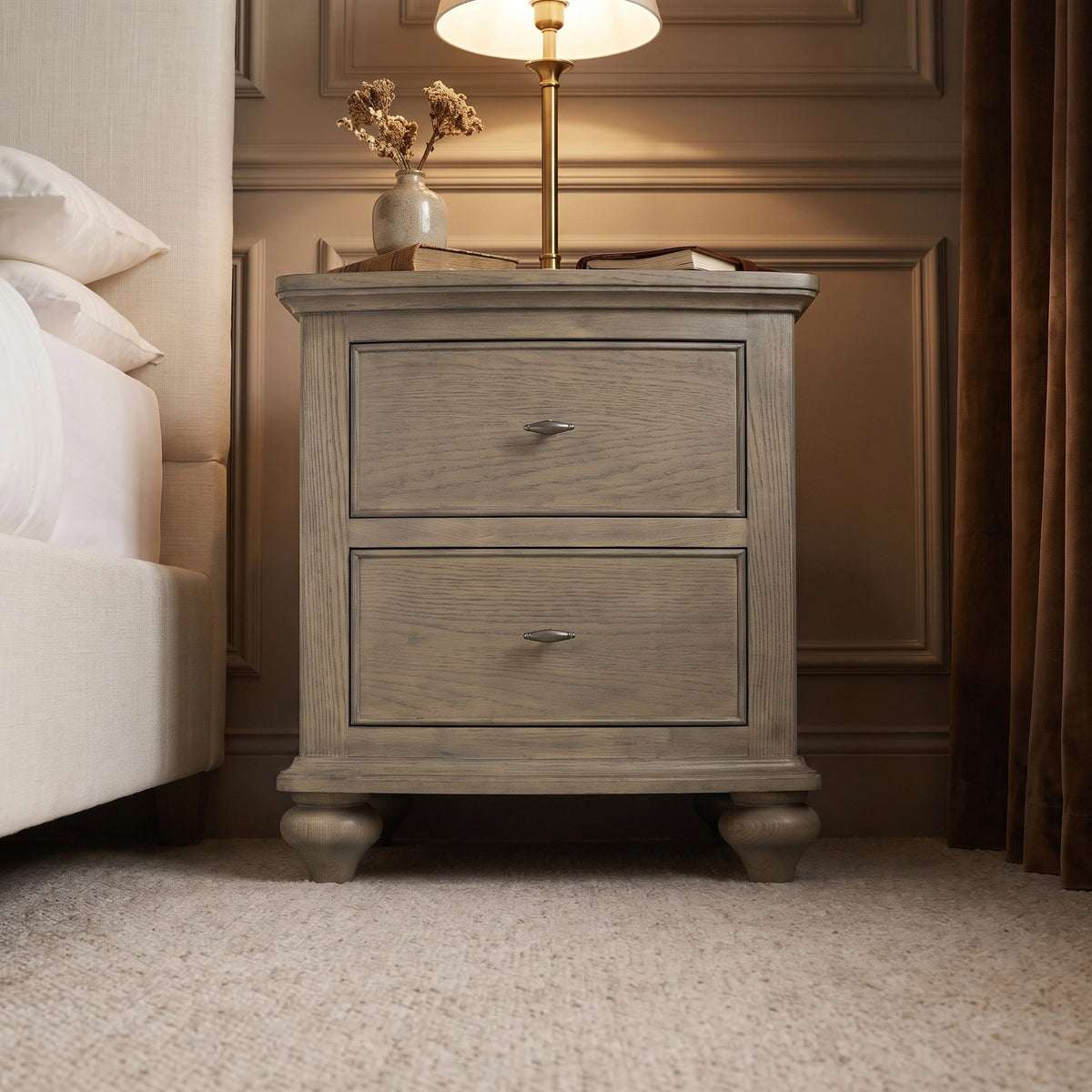 a nightstand with a lamp on top