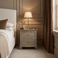 a nightstand next to a bed