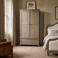 a bedroom with a bed and a large wardrobe
