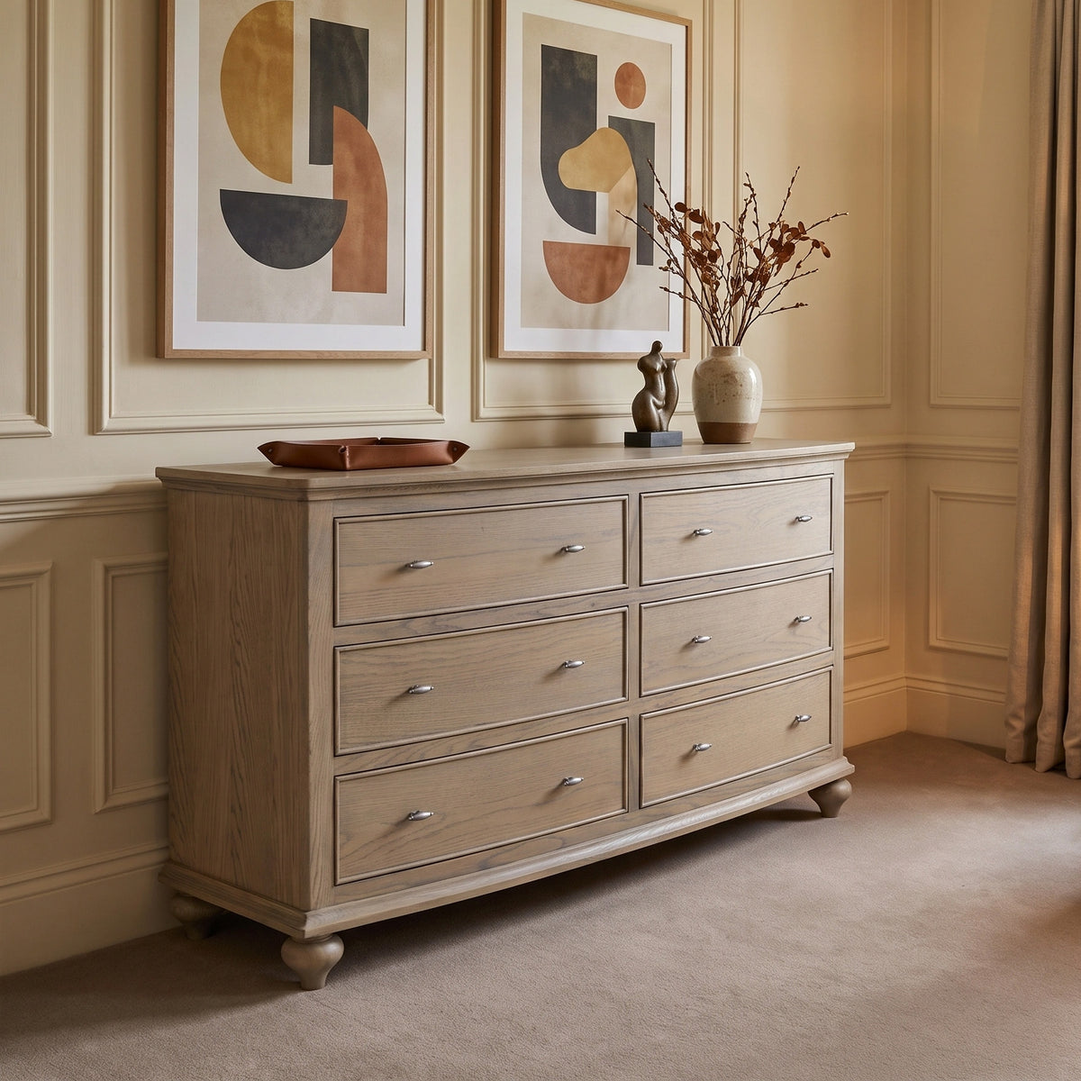 a dresser with art on the wall