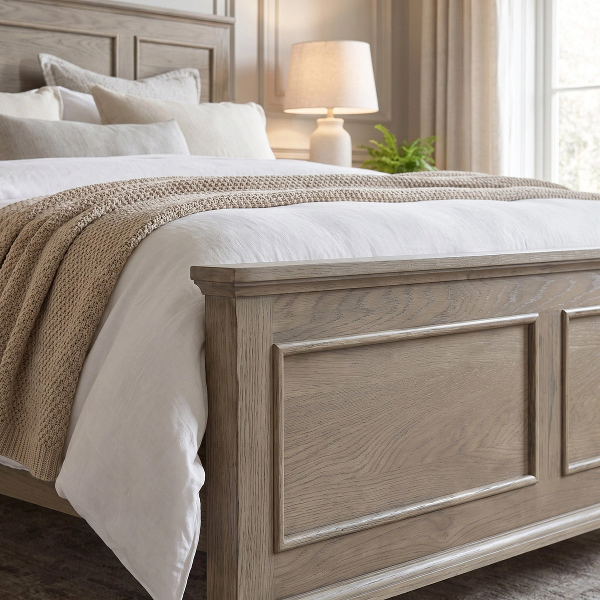 a bed with a wood headboard and a lamp