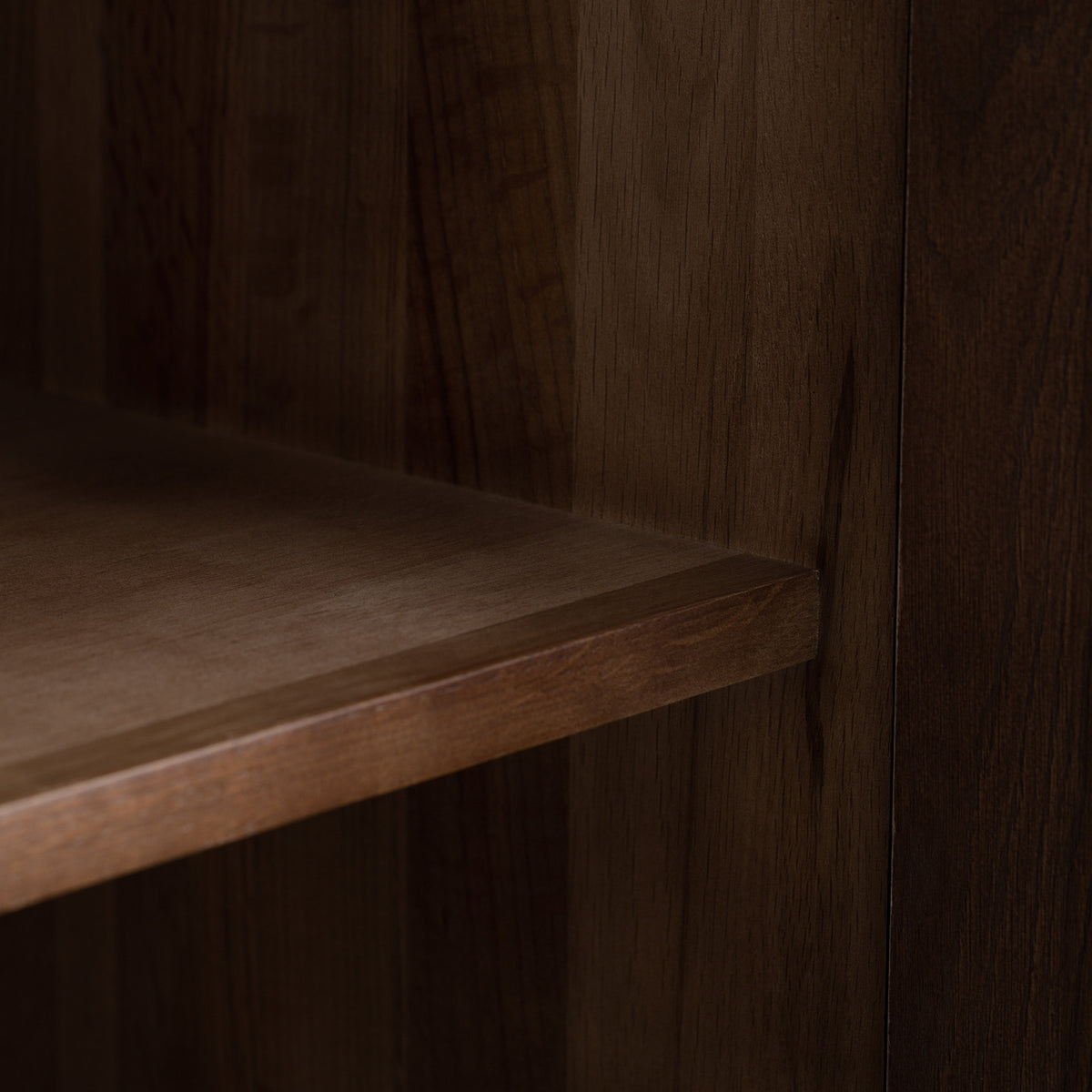 Close-up of the shelf corner on the Oslo 3 Door Sideboard with Shelves in Walnut, highlighting the seamless join between shelf and side panel, its sophisticated walnut finish, and adjustable shelving for flexible storage.