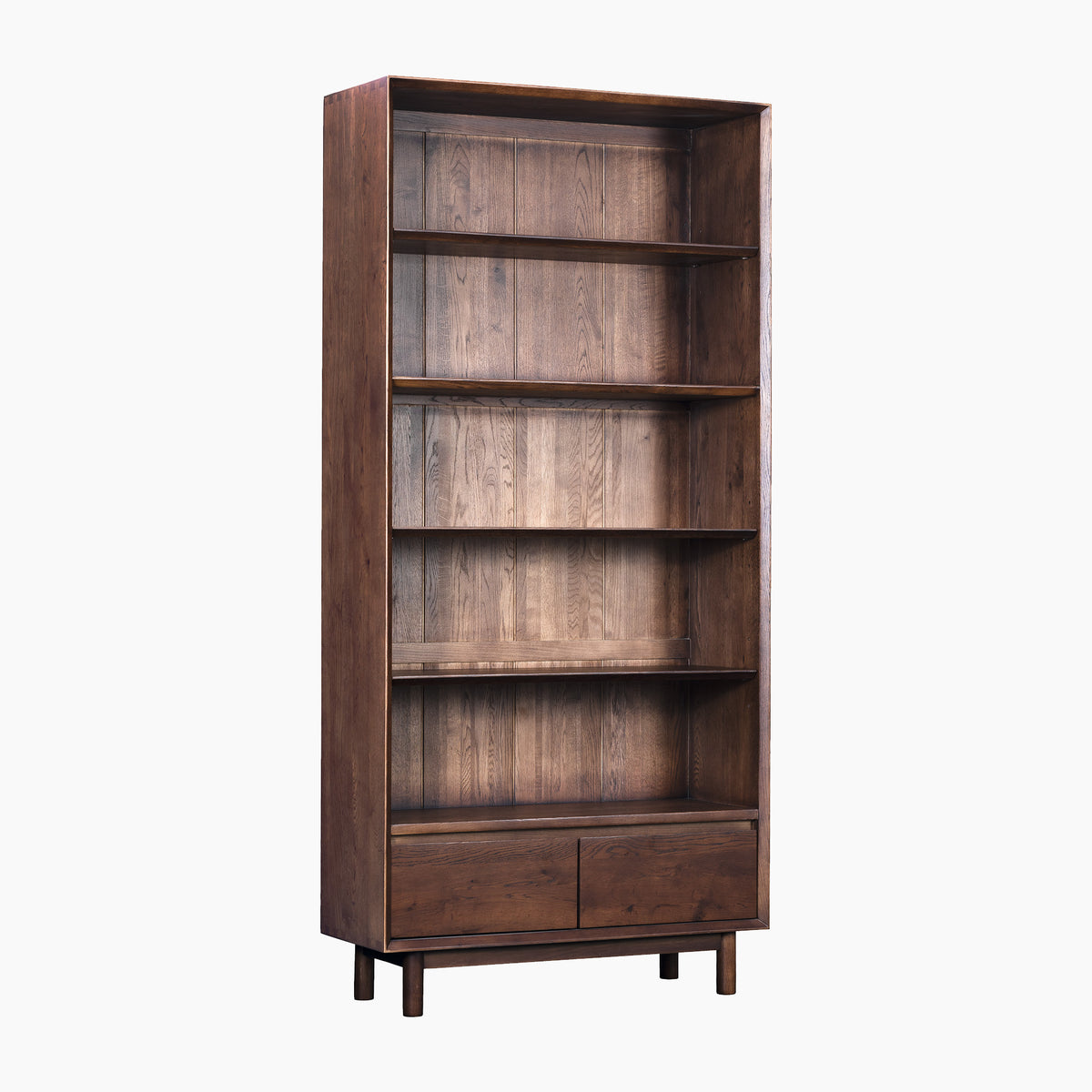 The Oslo Bookcase in Walnut features a tall wooden frame with five shelves and two drawers at the bottom, displayed against a plain white background.