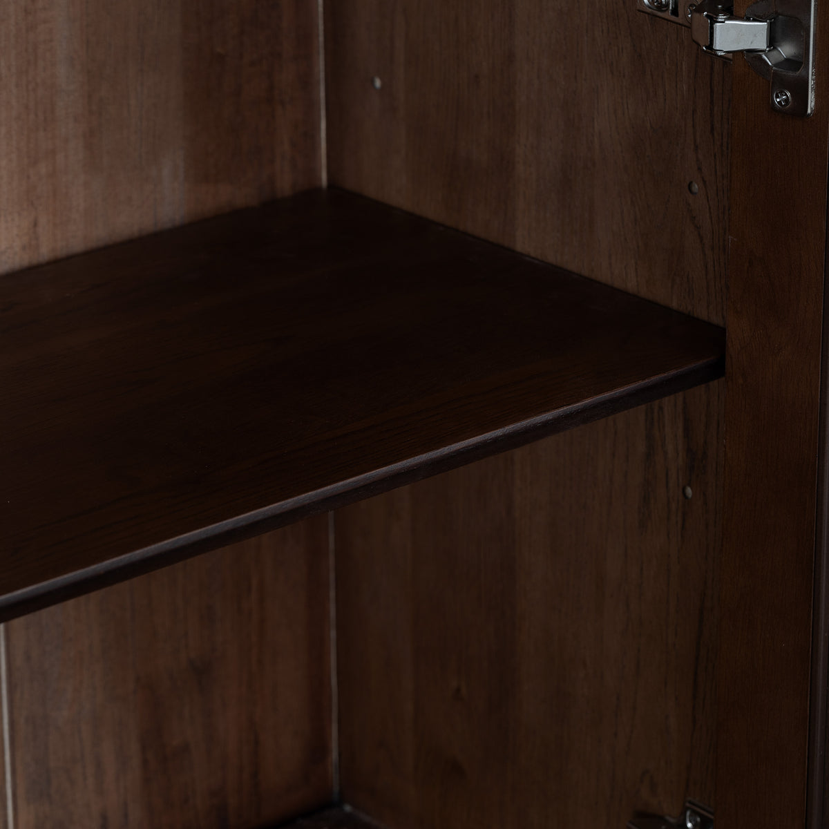 Dark walnut shelf inside an empty Oslo Display Cabinet in Walnut, with a visible metal hinge on the right side.