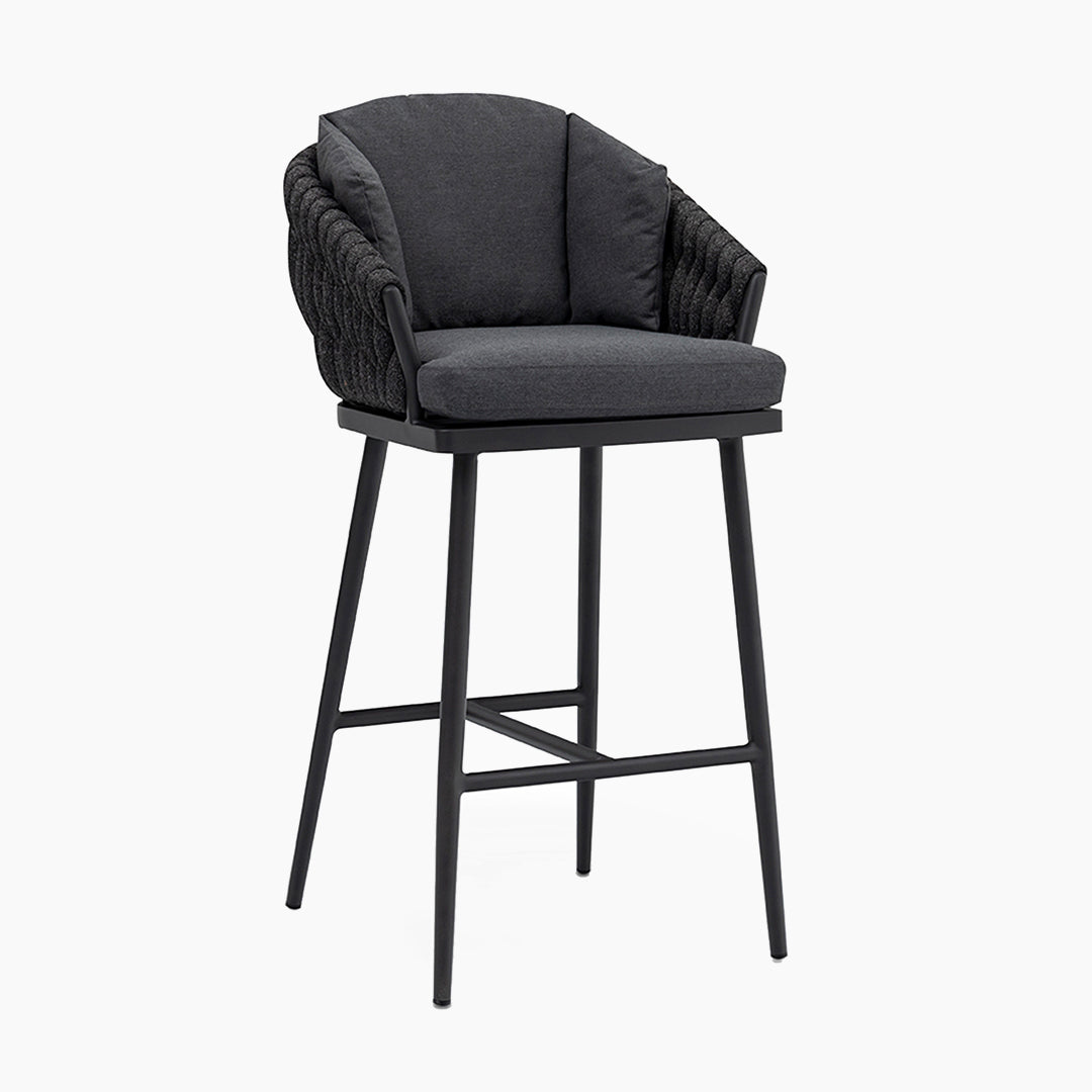 The Palma Rope Bar Stool in Grey features a black cushioned seat and backrest, complemented by black woven detailing and sturdy metal legs. Its UV-resistant materials make it perfect for any outdoor living area.