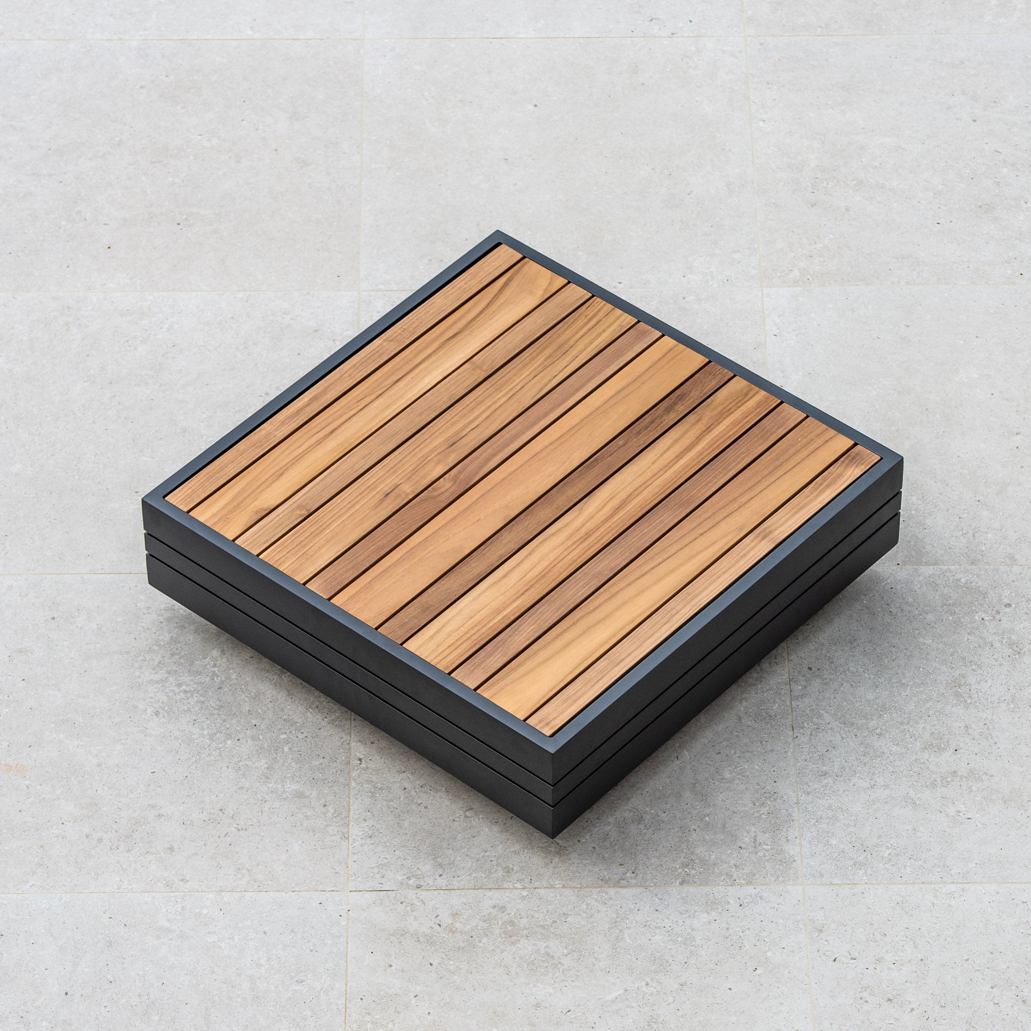 The Panama Luxury Outdoor L-Shape Corner Group Set in Washed Grey, featuring a sophisticated combination of wood and metal, sits elegantly on a light grey tiled floor.