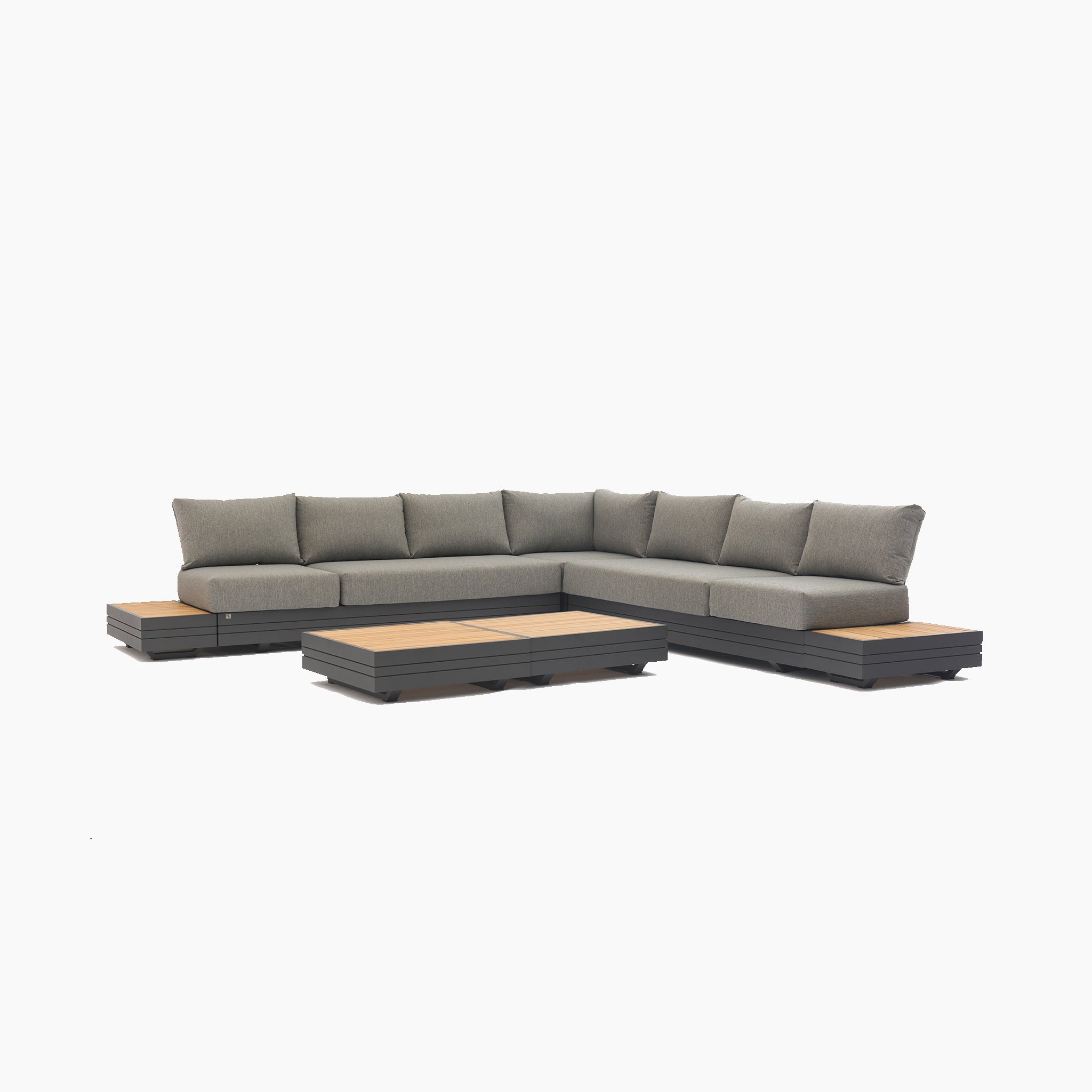 The Panama Luxury Outdoor Large Corner Group Set in Washed Grey features an L-shaped sectional sofa with wooden accents on the armrests and a matching low coffee table, all crafted from sustainable teak.