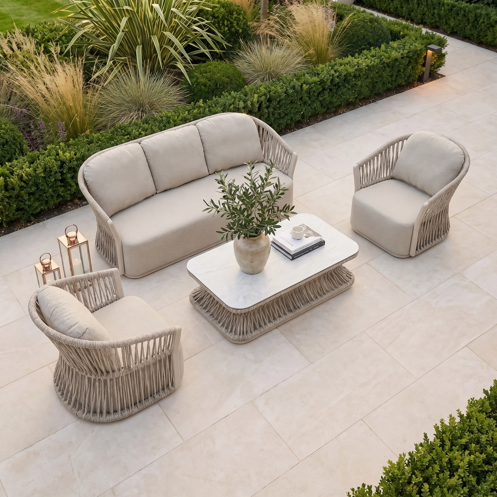 Outdoor patio featuring the Pello 3 Seat Sofa Set in Fawn with beige wicker frames, quick-dry cushions, and a marble coffee table topped with a potted plant.