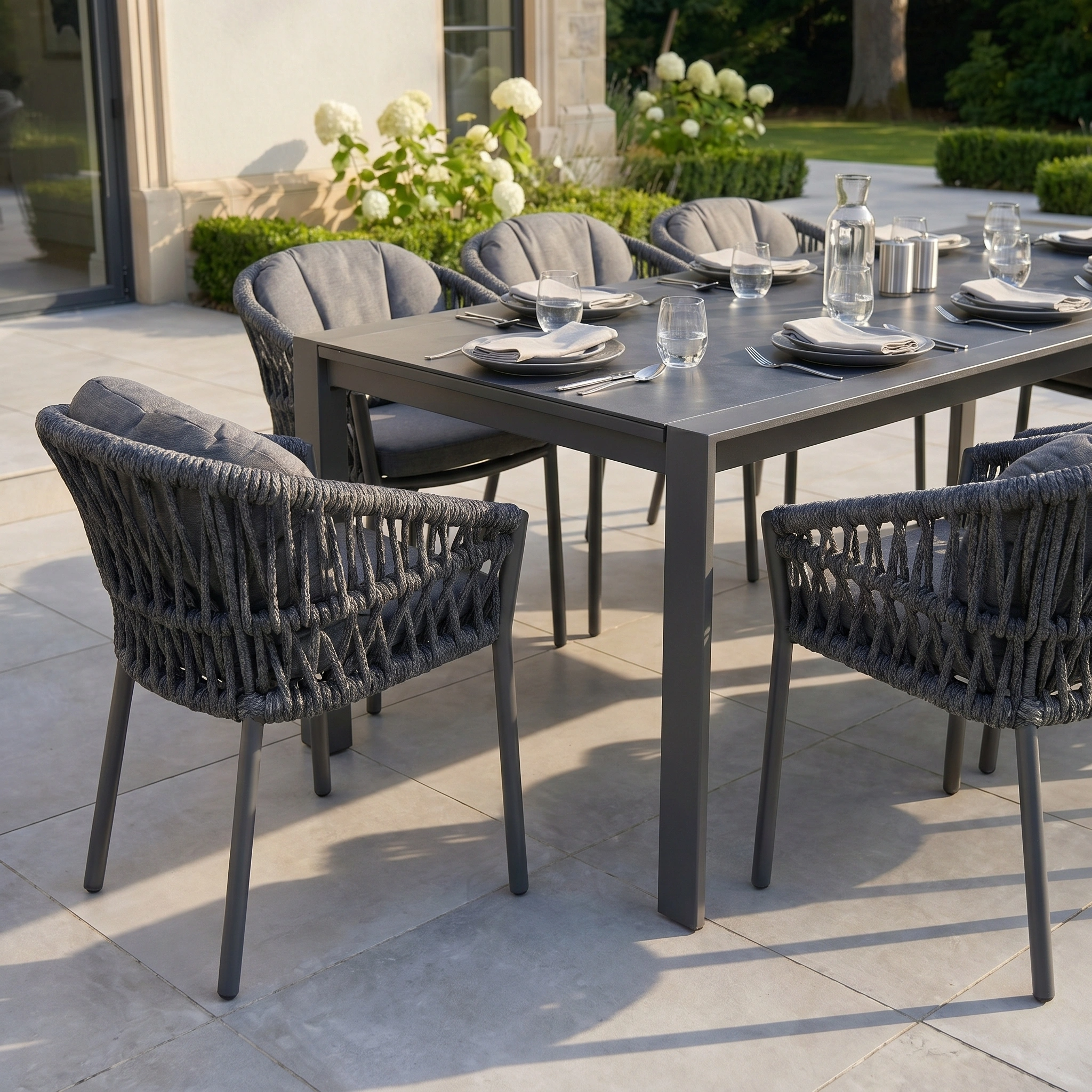 The Pello 8 Seat Extending Dining Set with Ceramic Table in Grey features weather-resistant construction and comfortable cushioned chairs, making it perfect for stylish outdoor gatherings or dining on your patio.