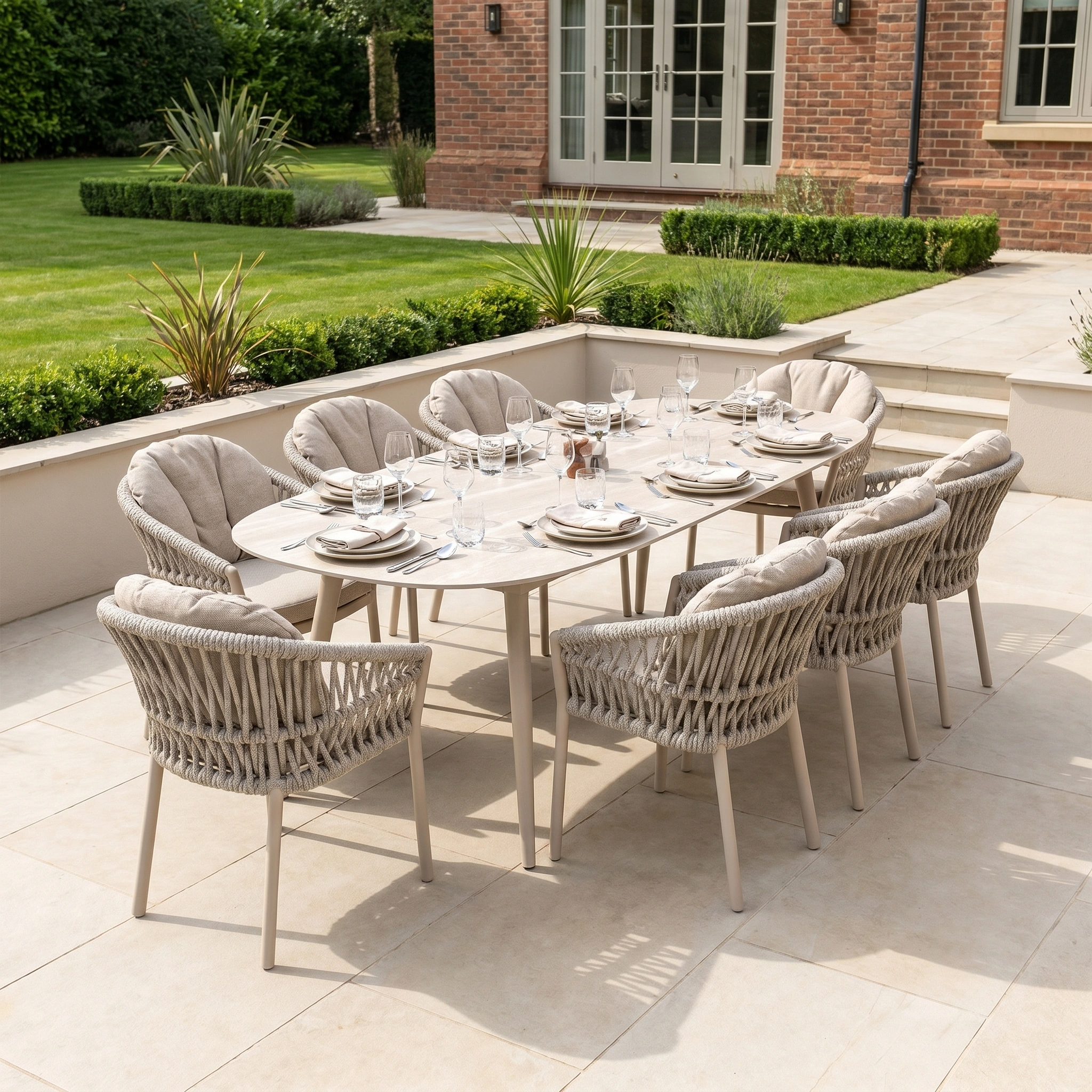 The Pello 8 Seat Oval Dining Set with Ceramic Table in Fawn seats eight, offering weather-resistant comfort for gatherings on your patio or garden beside your brick house. Perfect for stylish outdoor dining.