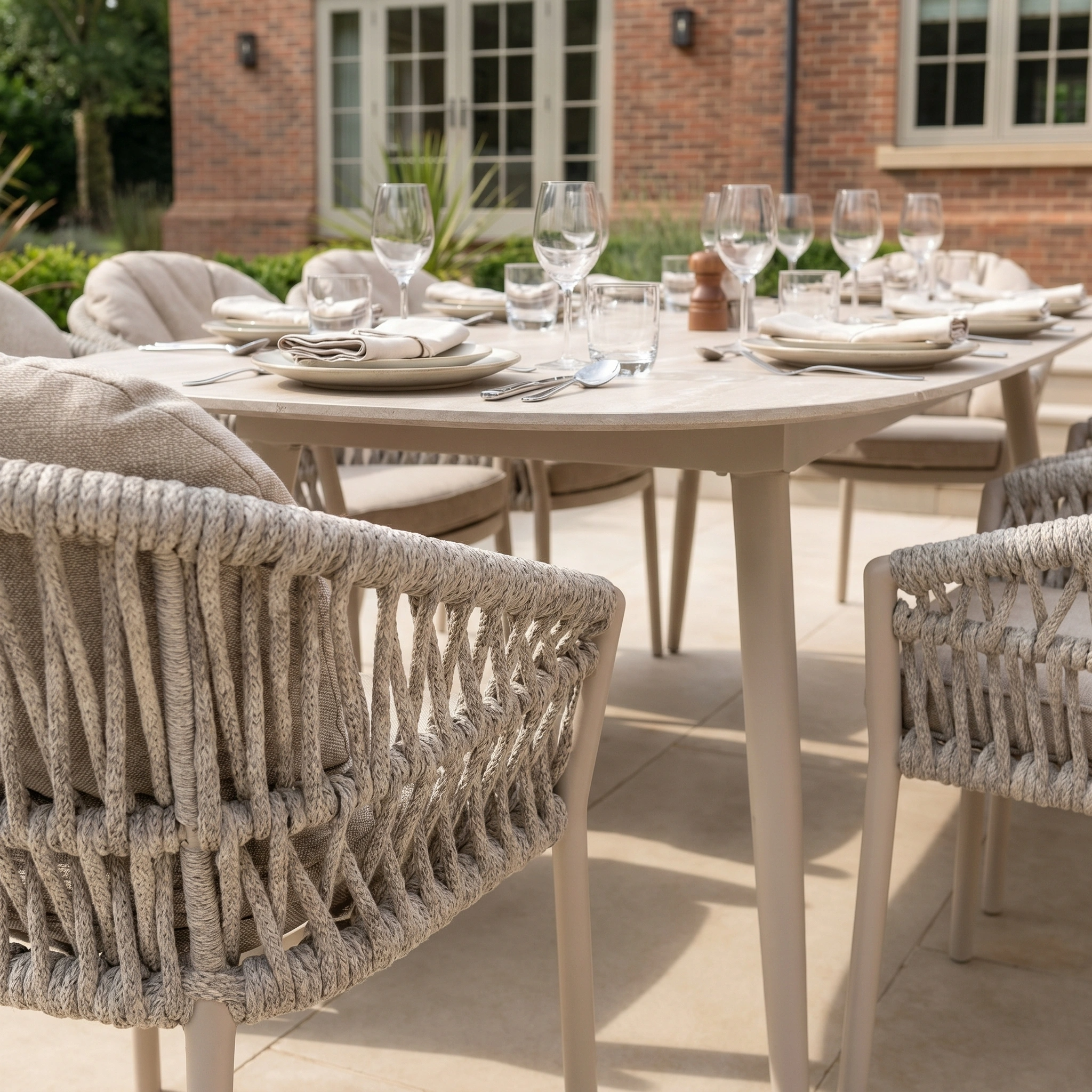 The Pello 8 Seat Oval Dining Set with Ceramic Table in Fawn features weather-resistant garden furniture and woven chairs, perfect for memorable outdoor gatherings on your patio.