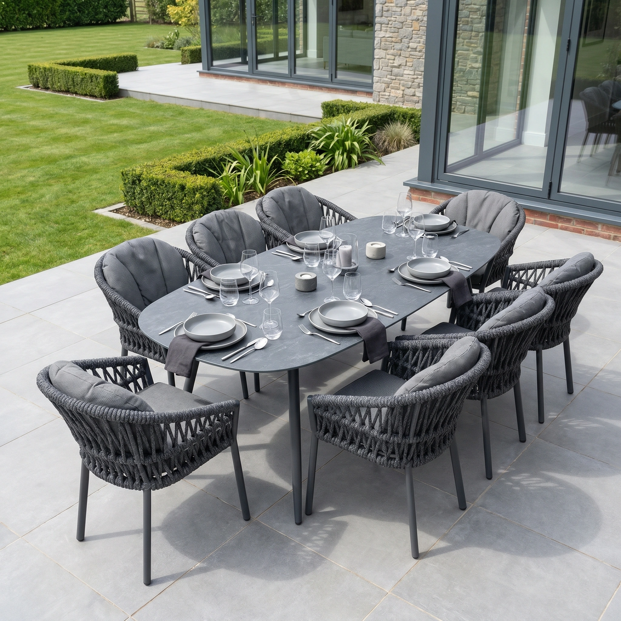 The Pello 8 Seat Oval Dining Set with Ceramic Table in Grey is a weather-resistant, stylish patio set featuring eight chairs—perfect for outdoor meals by your garden or glass doors.