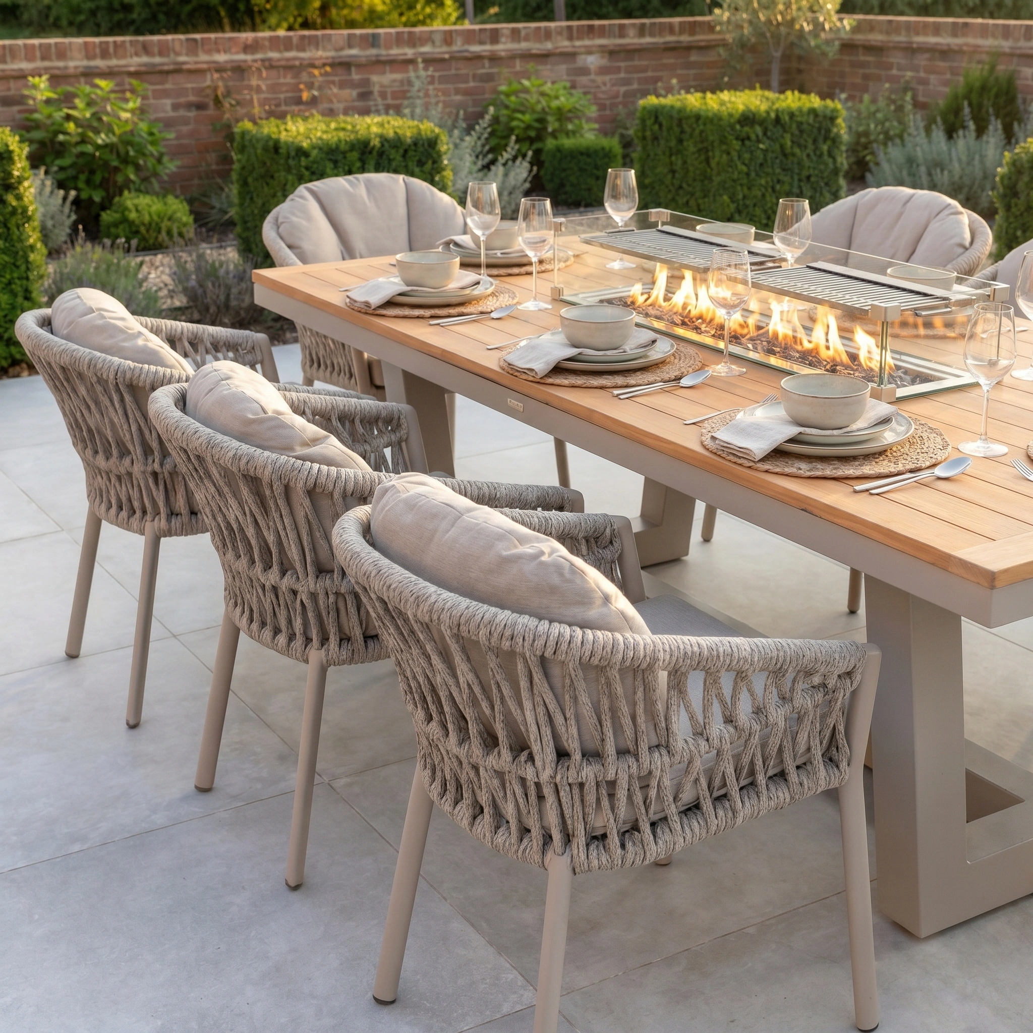 The Pello 8 Seat Rectangular Teak Firepit Dining Set in Fawn features a built-in firepit and seating for eight, making it the perfect inviting outdoor setup for dining and gatherings.