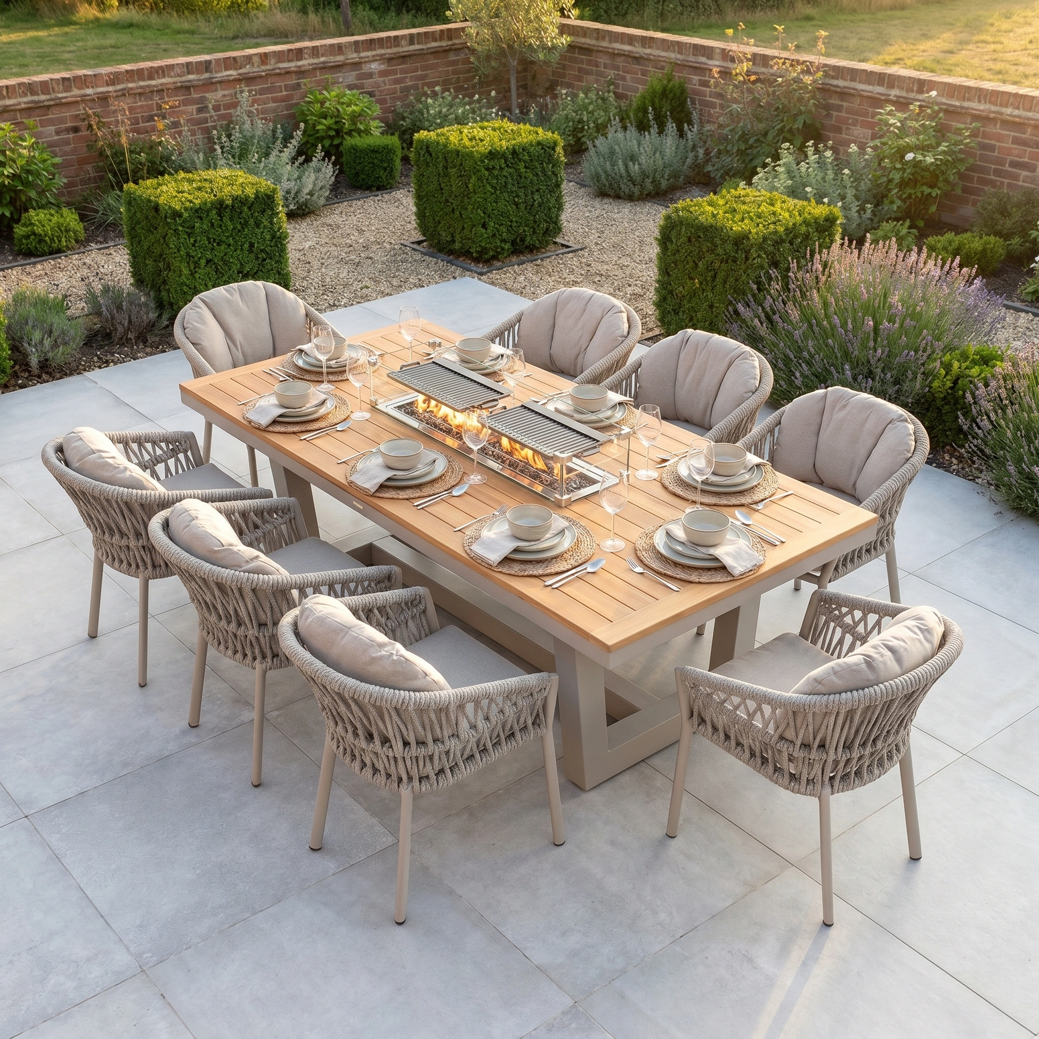 The Pello 8 Seat Rectangular Teak Firepit Dining Set in Fawn features cushioned chairs and a teak table with two built-in firepits, making it the ideal patio set for outdoor dining and entertaining.
