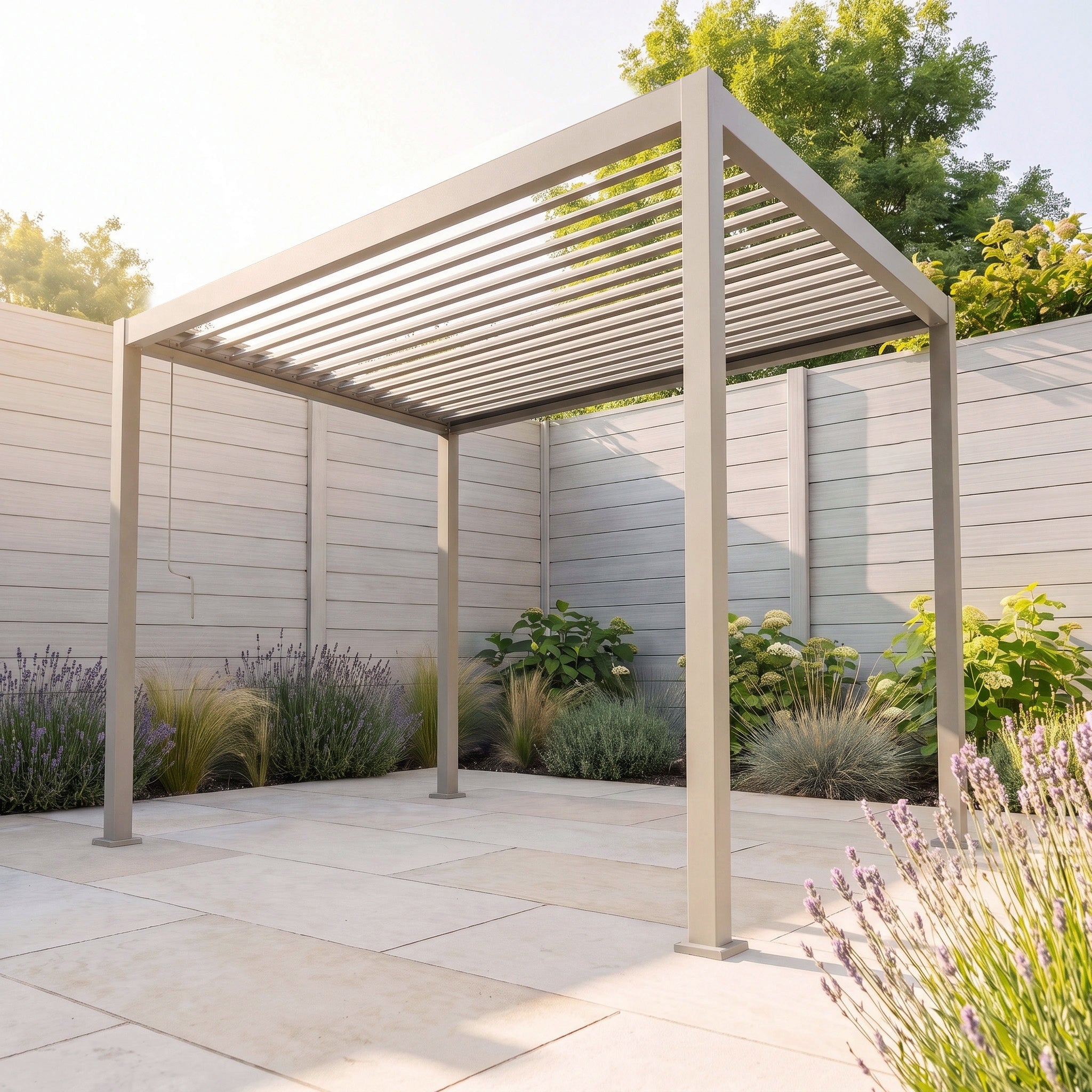 The PergoSTET Lite 2.4m x 3m Metal Rectangular Pergola in Latte, featuring tilting louvres, stands on a tiled patio surrounded by plants and a tall wooden fence.