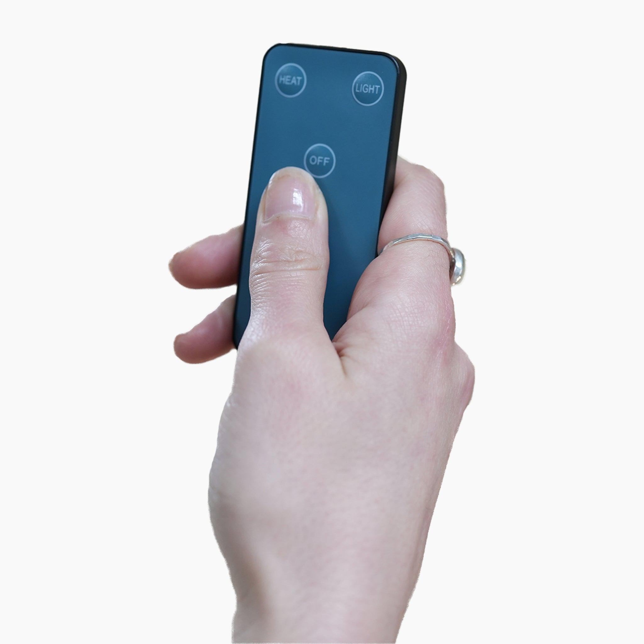 Hand holding a small grey remote with buttons labeled "HEAT," "LIGHT," and "OFF," showcasing the remote-controlled functionality of the FREE PergoSTET Wifi & Bluetooth Heater.