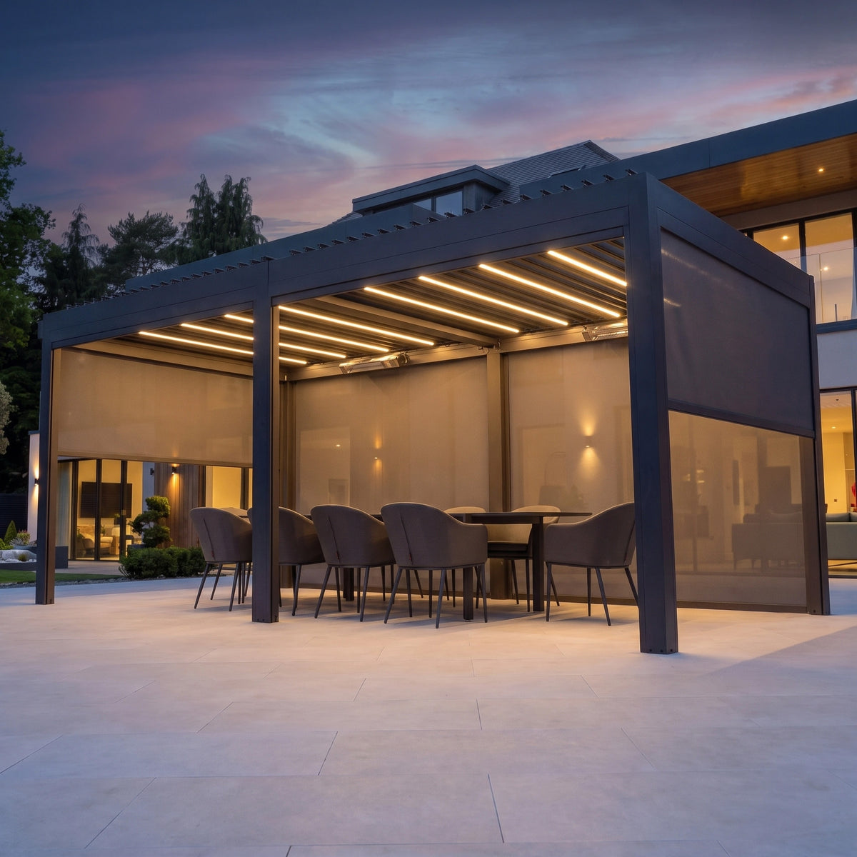 PergoSTET Deluxe 3m x 6m Rectangular Pergola with integrated LED lighting and side blinds at dusk.