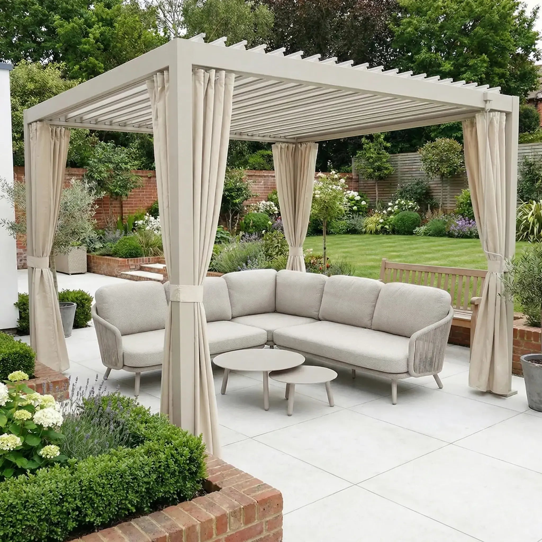 Modern garden pergola featuring PergoSTET Side Curtains for Lite and Lite Neo 3m x 3m Square Pergola in Latte, a corner sofa, coffee tables, and lush greenery in the background.