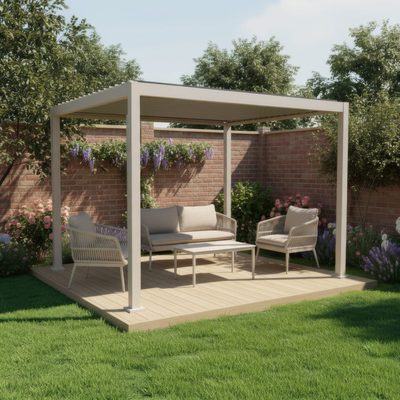 The PergoSTET Lite 3m x 3m Metal Square Pergola in Latte features tilting louvres and provides stylish outdoor seating on a wooden deck, surrounded by garden flowers and brick walls.