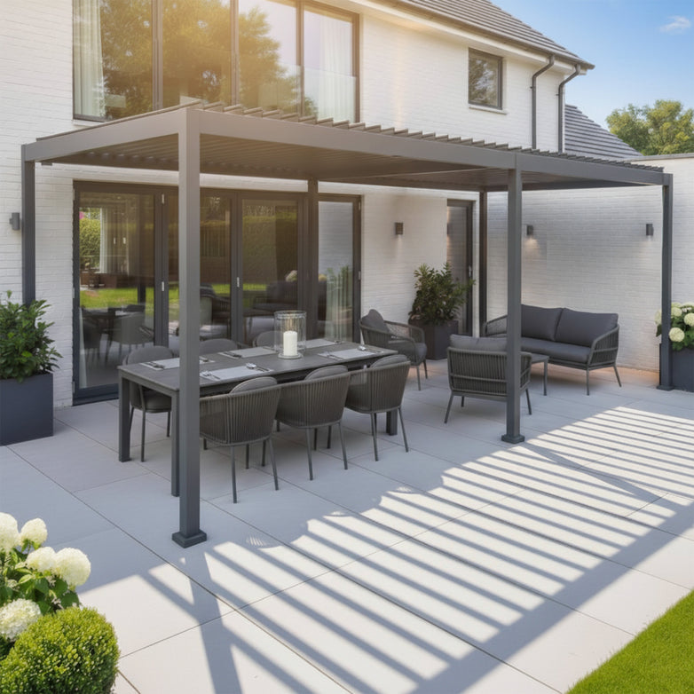 The PergoSTET Lite Neo 3m x 7m Metal Rectangular Pergola in Grey offers adaptable shade for a modern patio with dining table, chairs, and sofa set on tiled flooring beside the house, creating an inviting outdoor space.