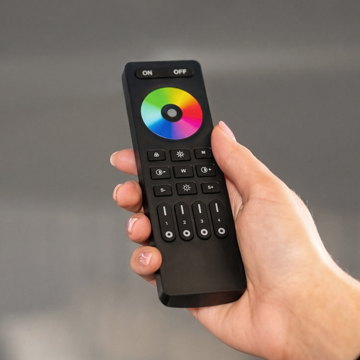 a hand holding a remote control