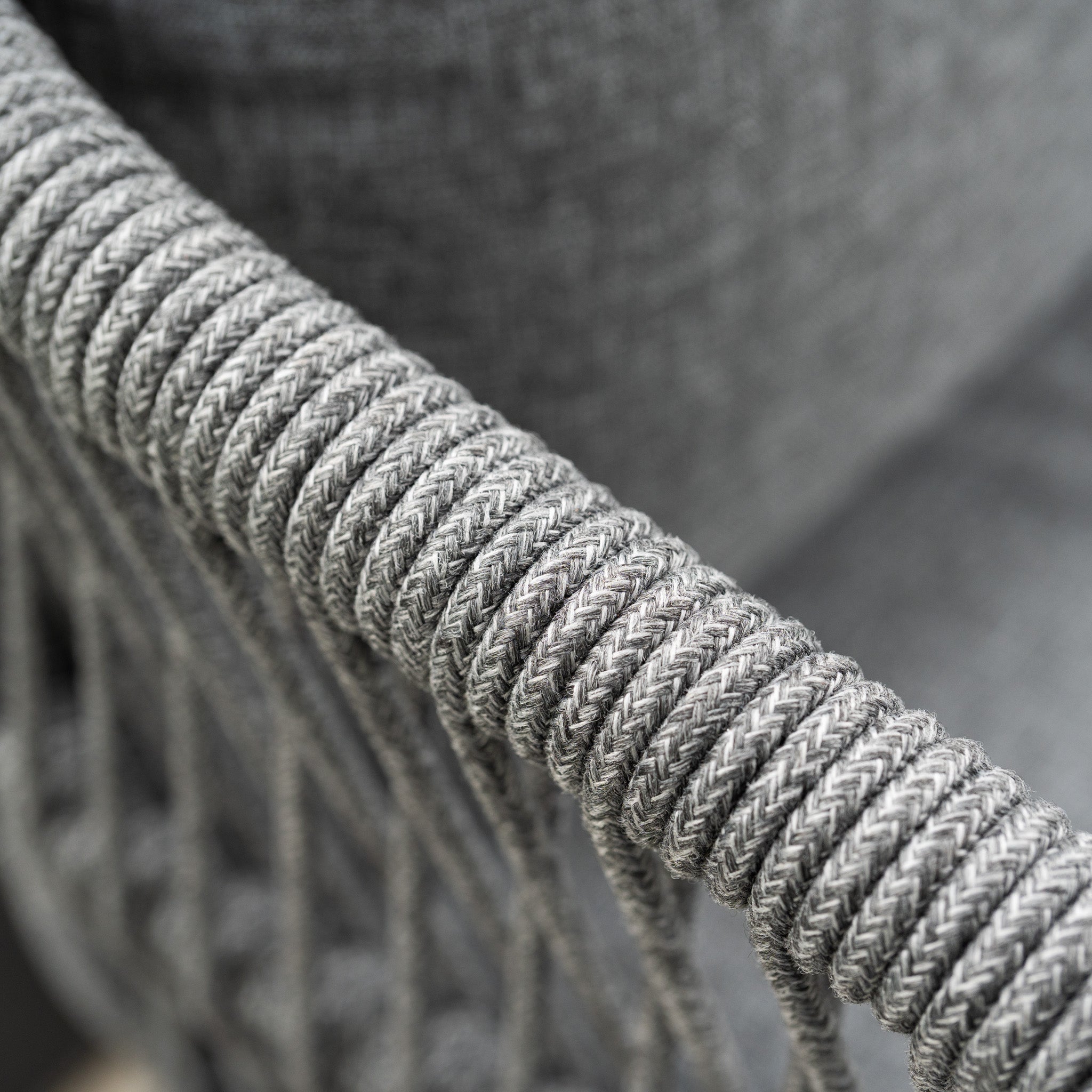 Close-up of a gray woven rope detail on the armrest of the Rhea 2 Seat Sofa Set in Grey, showcasing its stylish texture as part of this contemporary garden set.