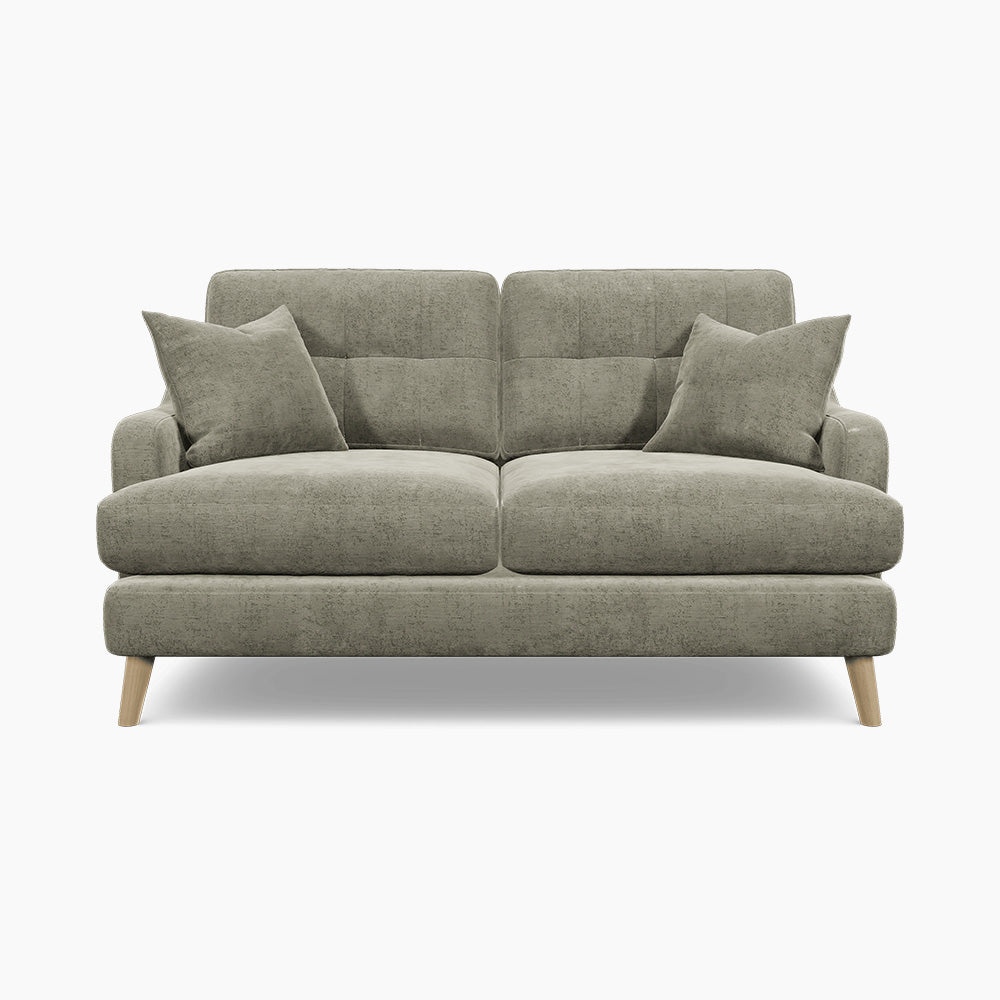 a grey couch with two pillows