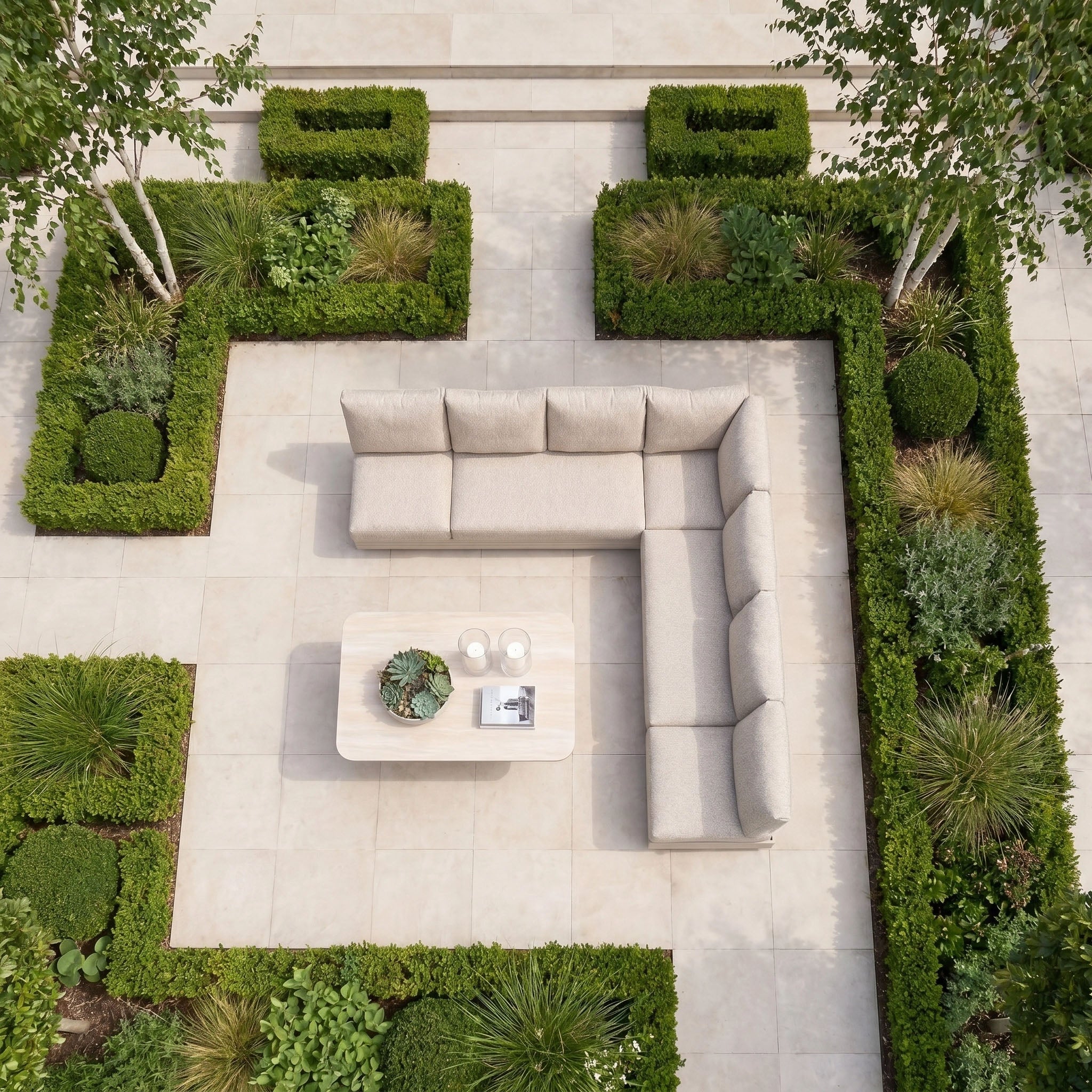 Modern patio with the Savona Luxury Outdoor Large Corner Sofa Set and Altura Rising Table in Oatmeal, surrounded by manicured hedges.