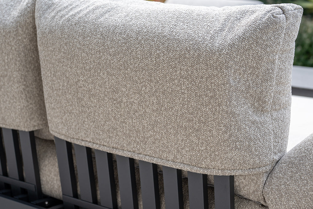 Close-up of the Savona 3 Seat Sofa with Sun Lounger Feature in Truffle, showing its light gray textured cushion and black slatted metal frame, emphasizing its UV-resistant garden furniture design.