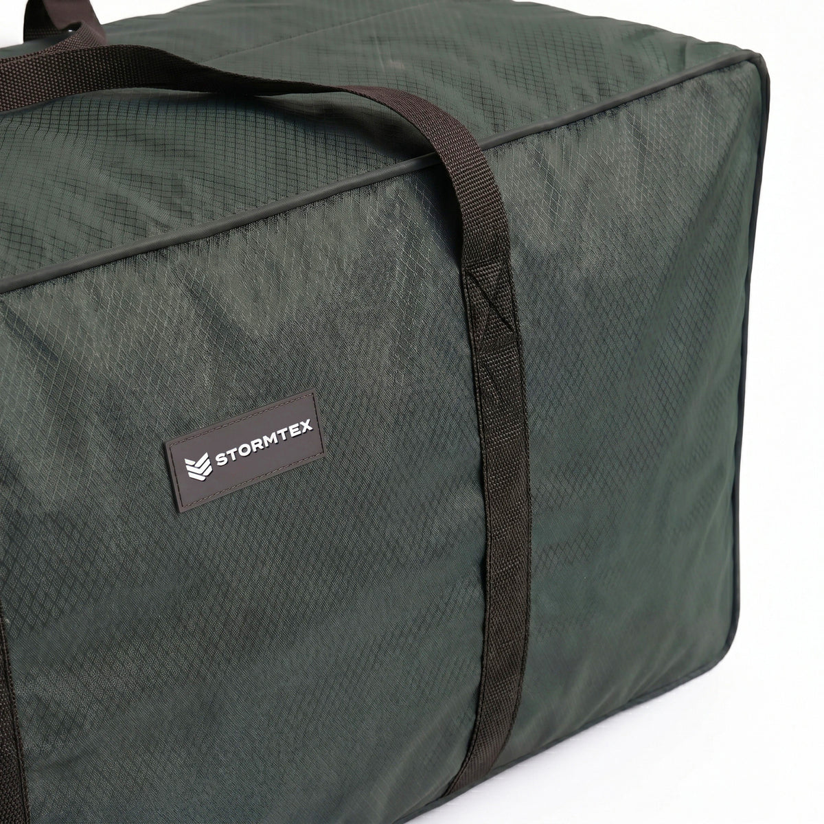 The Stormtex Cushion Storage Bag 145 x 100 x 100cm is a dark green duffel with black straps and a “STORMTEX” label on the side, designed as a waterproof cushion bag for secure and convenient storage, shown against a white background.