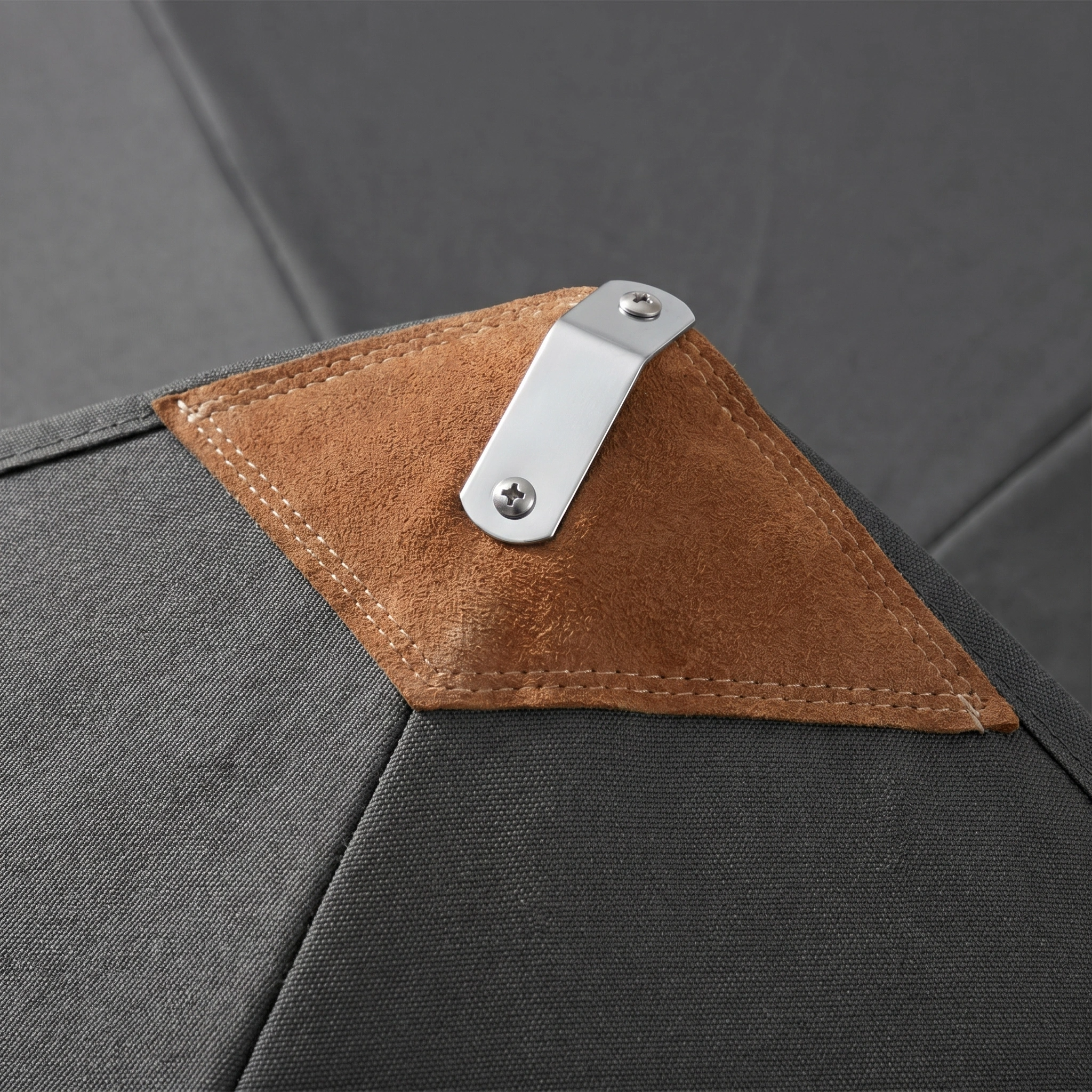 Close-up of the Styx 3m Round Deluxe Wooden Parasol in Grey, featuring sturdy grey fabric, a brown suede patch, and a metal clip secured by screws—highlighting the parasol's premium, durable materials.