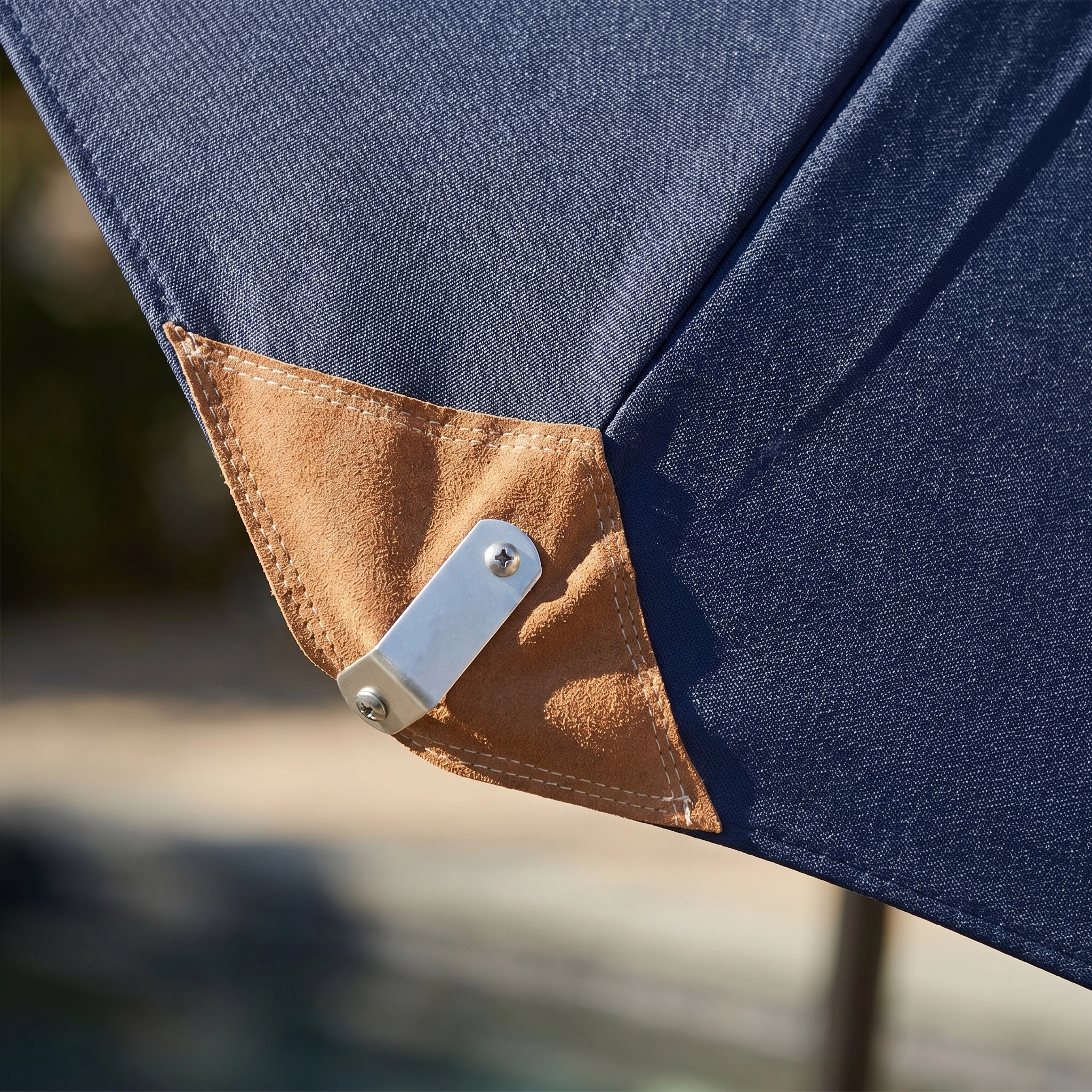 Close-up of the Styx 3m Round Deluxe Wooden Parasol in Navy, featuring a blue polyester canopy, tan reinforced corner, and sturdy metal bracket—perfect as a stylish addition to any outdoor garden setting.