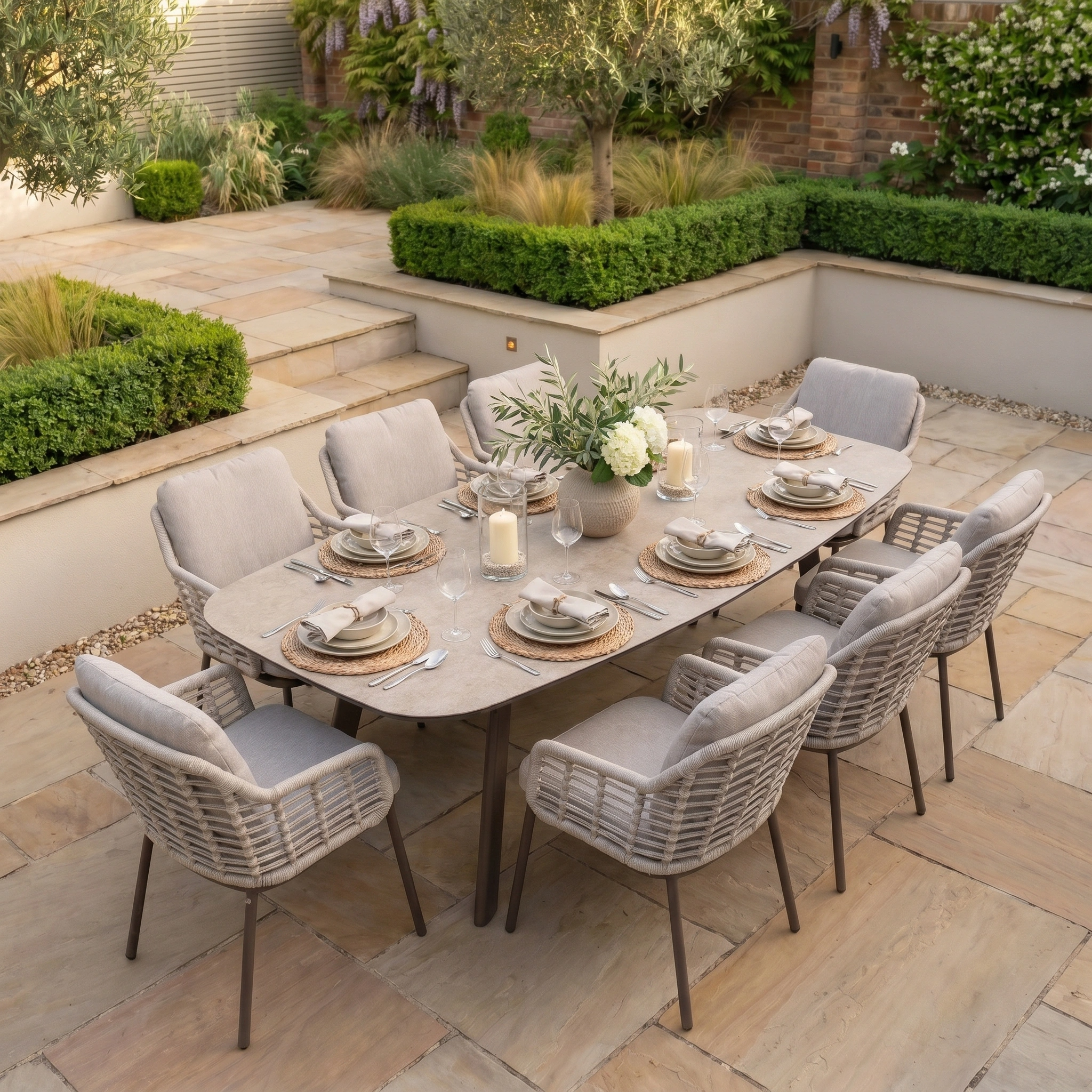 The Sutera 8 Seat Curved Rectangular Dining Set in Putty brings elegant, all-weather outdoor dining to your landscaped garden patio—ideal for relaxed al fresco gatherings with neutral decor.