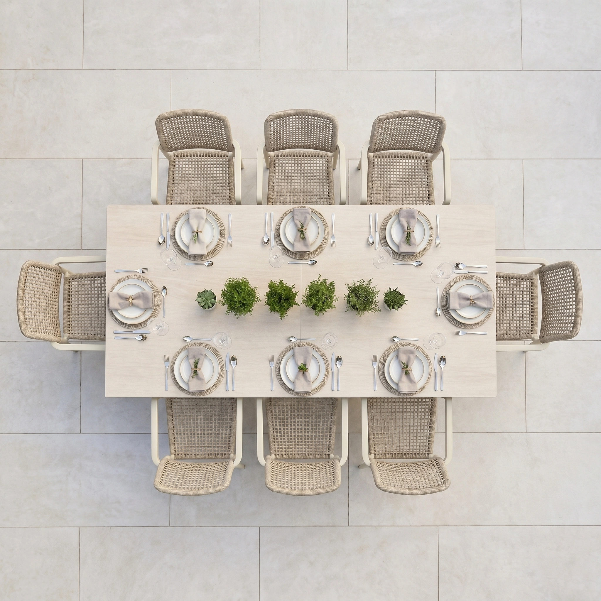Top view of the Tolo 8 Seat Extending Dining Set in Oatmeal, styled with center green plants and woven chairs on a tiled floor—elegant outdoor dining furniture ideal for gatherings.