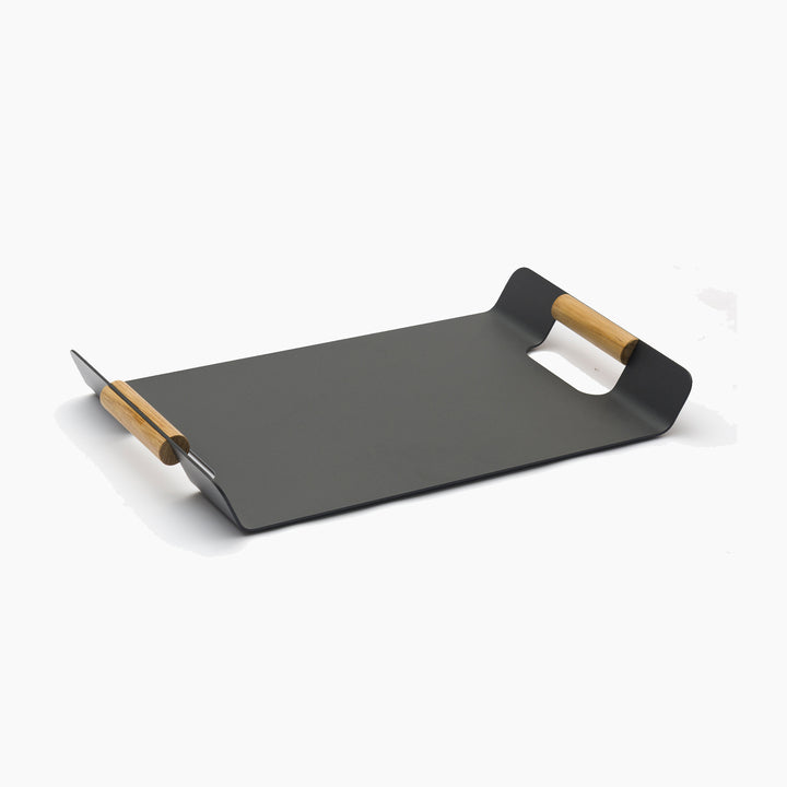 The FREE Tracy Serving Tray with Teak Handles in Charcoal is a sleek, rectangular black tray that complements garden furniture sets in any outdoor space. Its minimalist design enhances aesthetics while serving functionality on a light background.