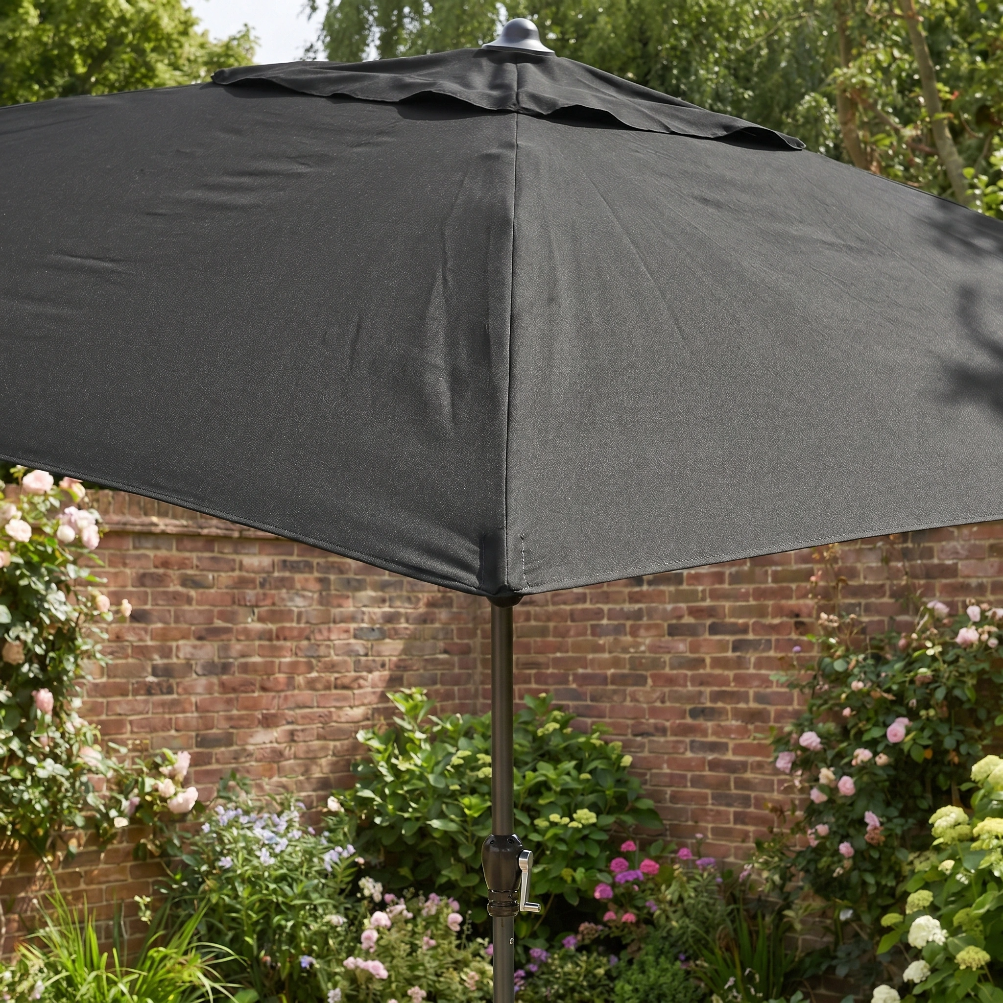 The Triton 3m x 2m Rectangular Aluminium Parasol in Black provides UV protection and features a sturdy aluminium frame, perfect for your garden with its sleek design.