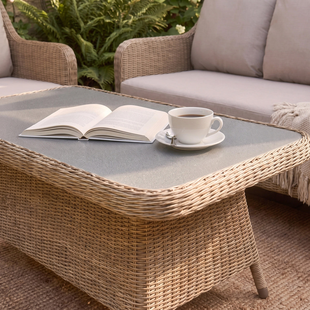 a coffee table with a book and a cup on it