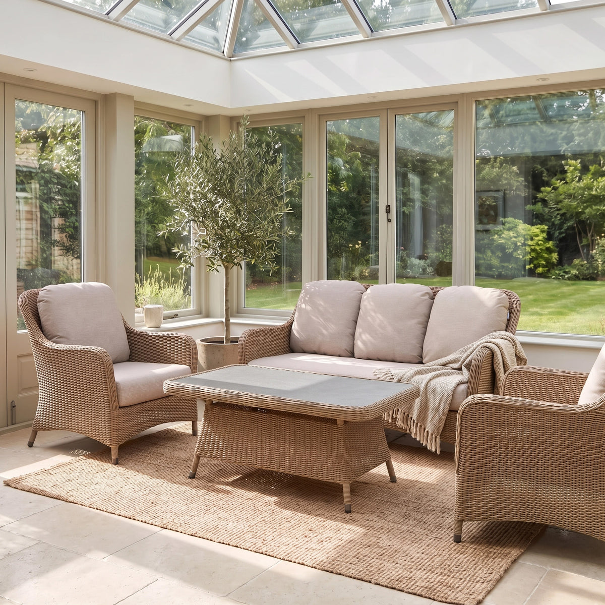 a sunroom with wicker furniture and a table