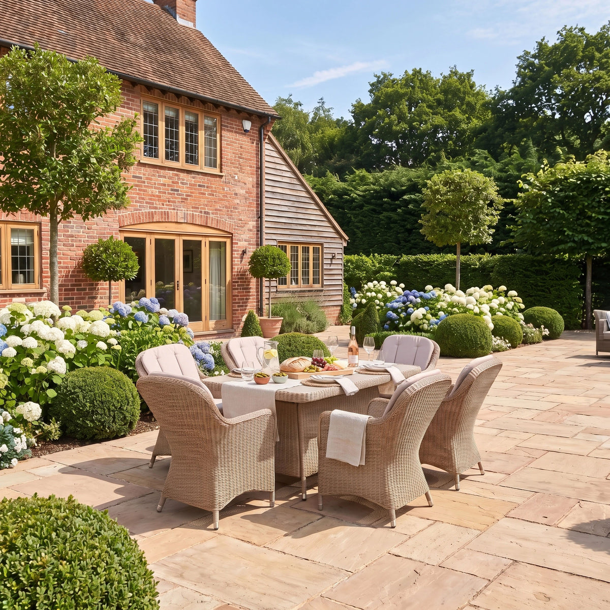 a patio with a table and chairs in front of a house