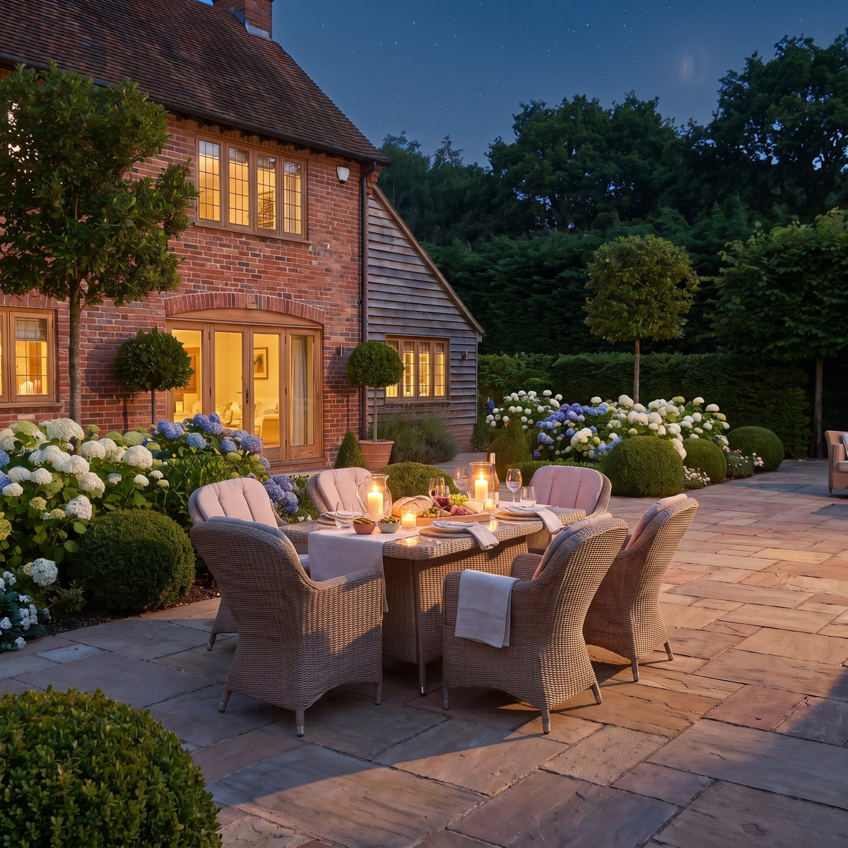 a patio with a table and chairs and a brick house