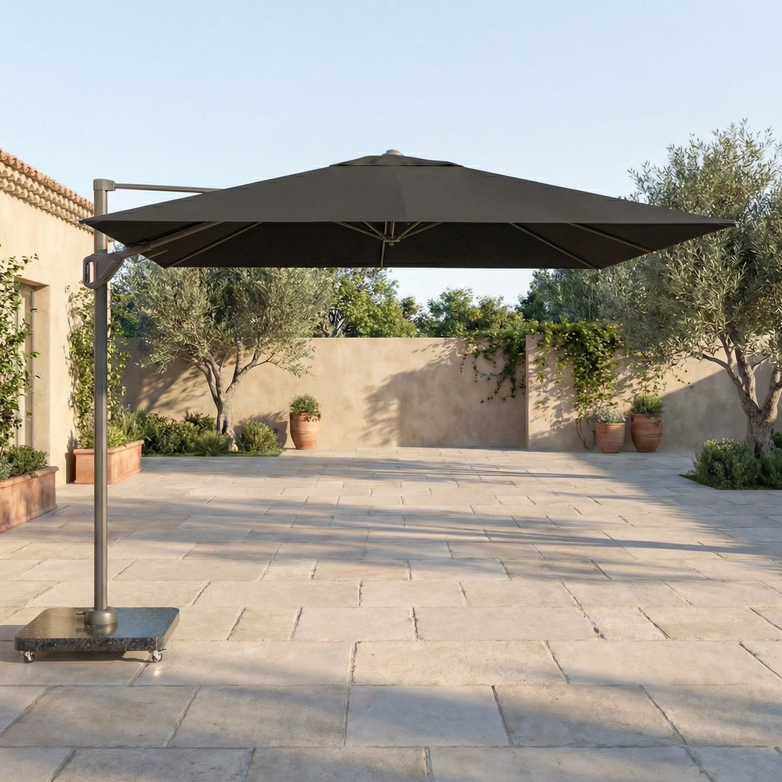 The Voyager T1 3m x 2m Rectangular Cantilever Parasol in Anthracite provides UV protection as it stands on a tiled terrace, surrounded by potted plants with a stone wall in the background.
