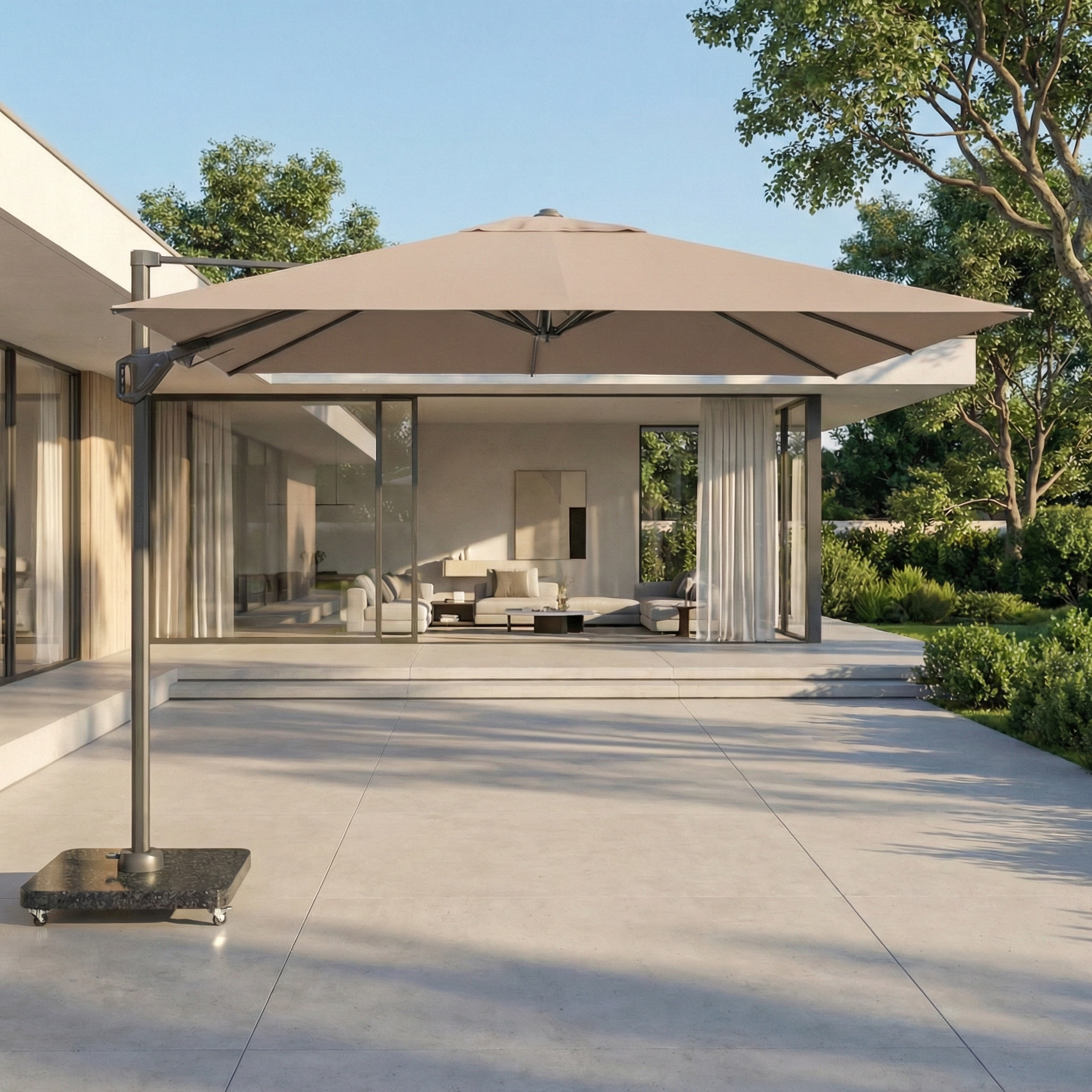 The Voyager T2 2.7m Square Cantilever Parasol in Taupe shades an outdoor seating area by a modern glass-walled house on a sunny day.