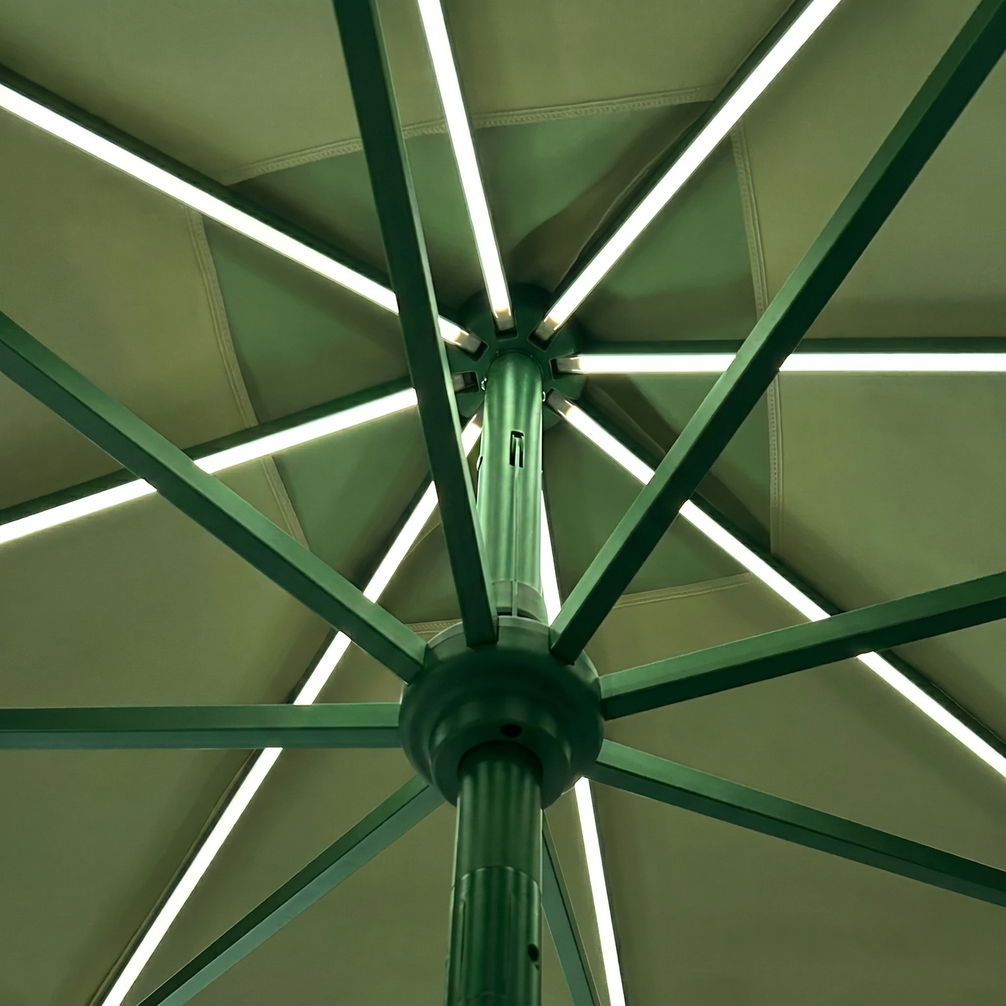 Beneath the Zelos 2.5M Round Parasol with LED Lighting in Green.