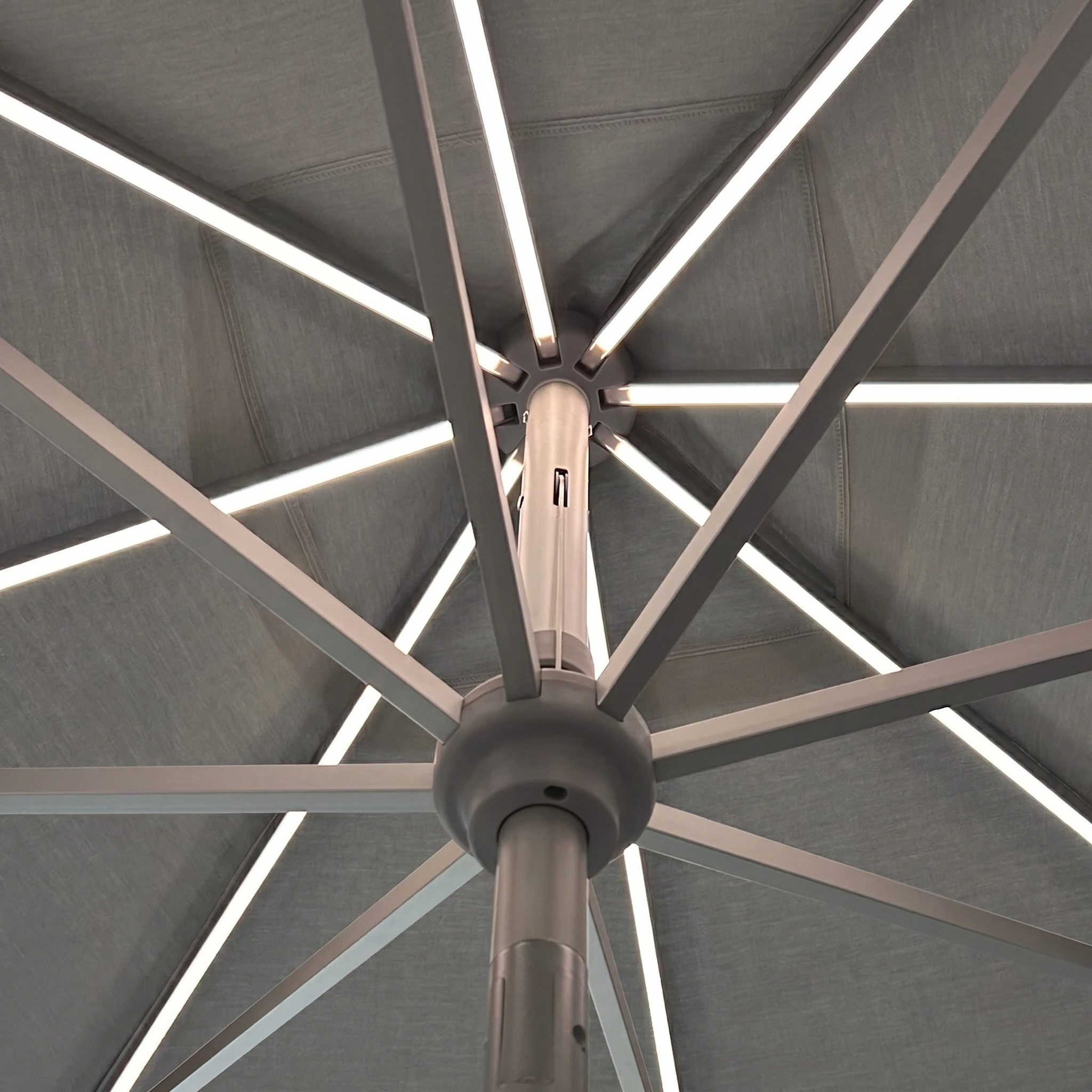 Close-up of the Zelos 3m Round Parasol with LED Lighting in Grey, featuring metal spokes and built-in LEDs for illumination and dependable UV protection.