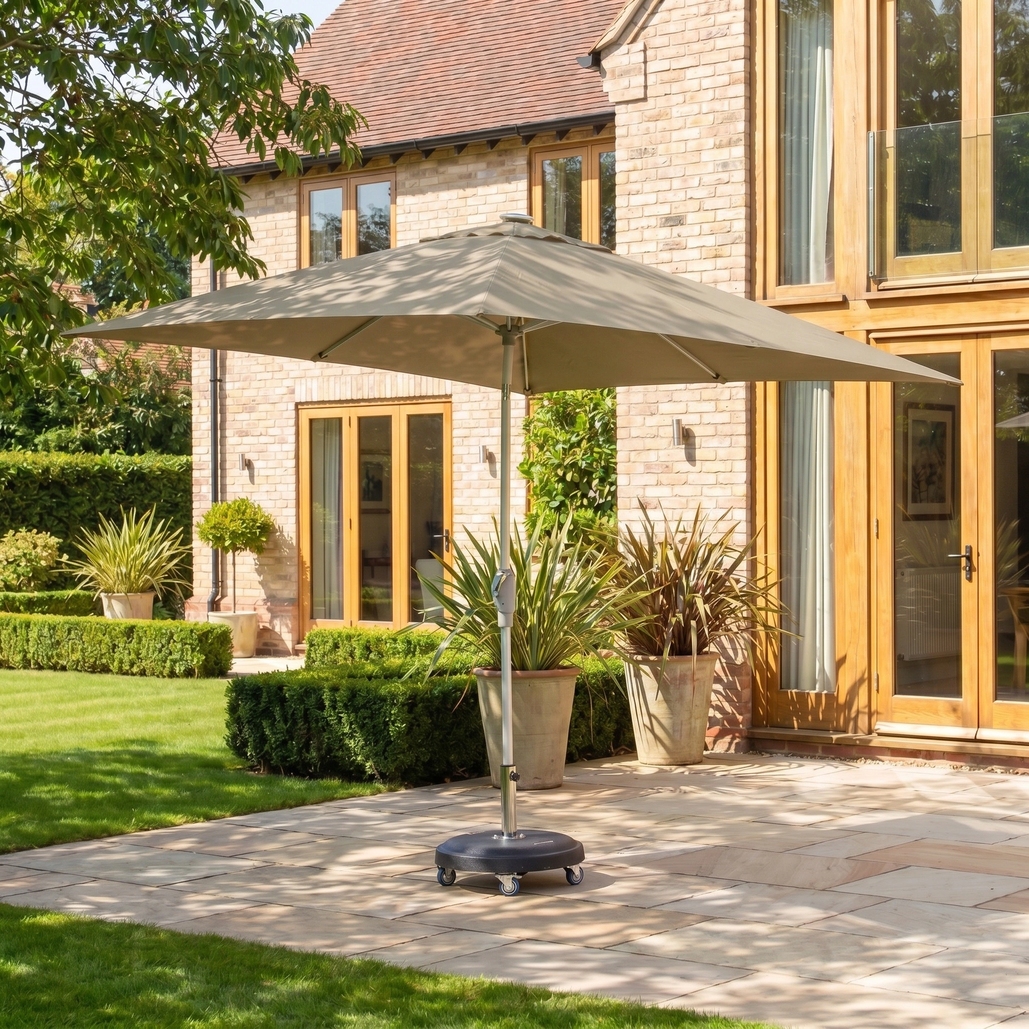 The Zelos 2.5m Square Parasol with LED Lighting in Taupe provides stylish shade and UV protection on your terrace, perfect for sunny gardens outside brick houses with wooden doors.