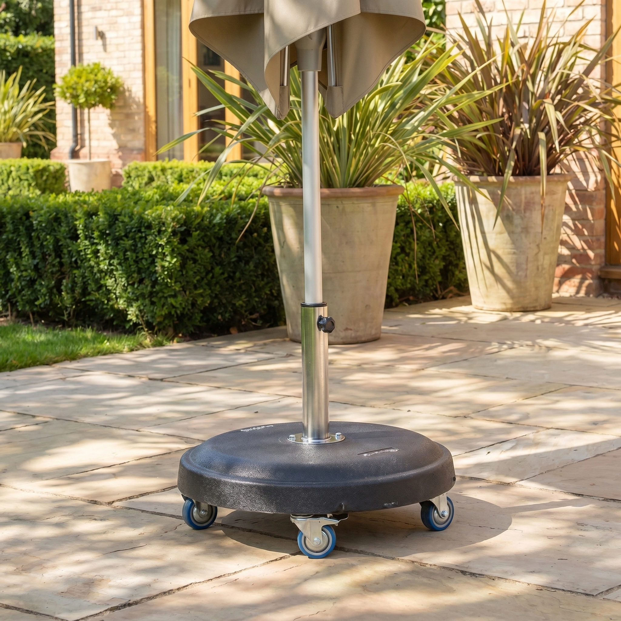 The Zelos 2.5m Square Parasol with LED Lighting in Taupe shades a stone patio filled with potted plants and lush greenery.
